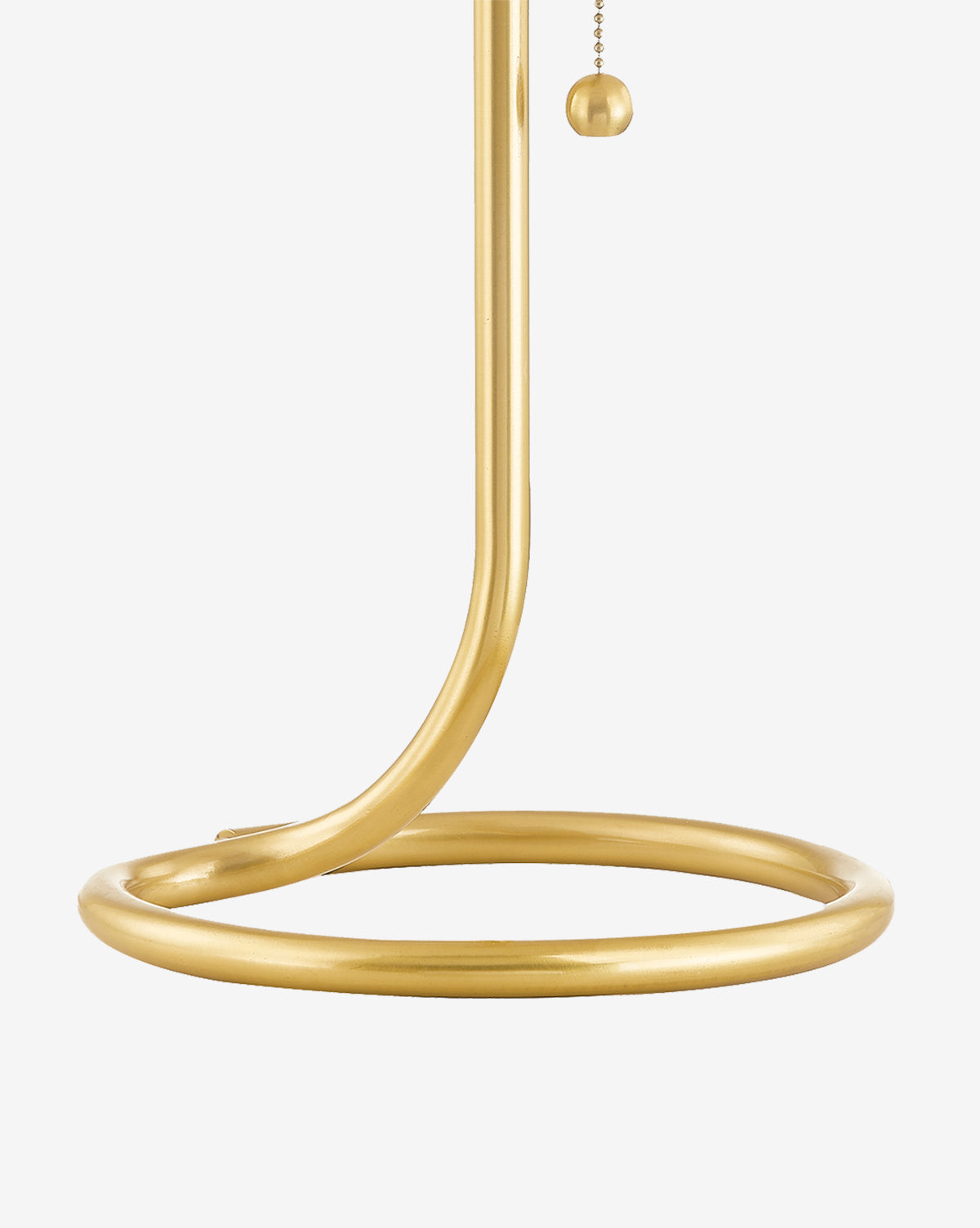 A close-up of the Martha Table Lamp’s modern gold base with a circular ring design and pull chain is shown against a white background—pair with a Belgian linen shade for timeless elegance, by McGee & Co.