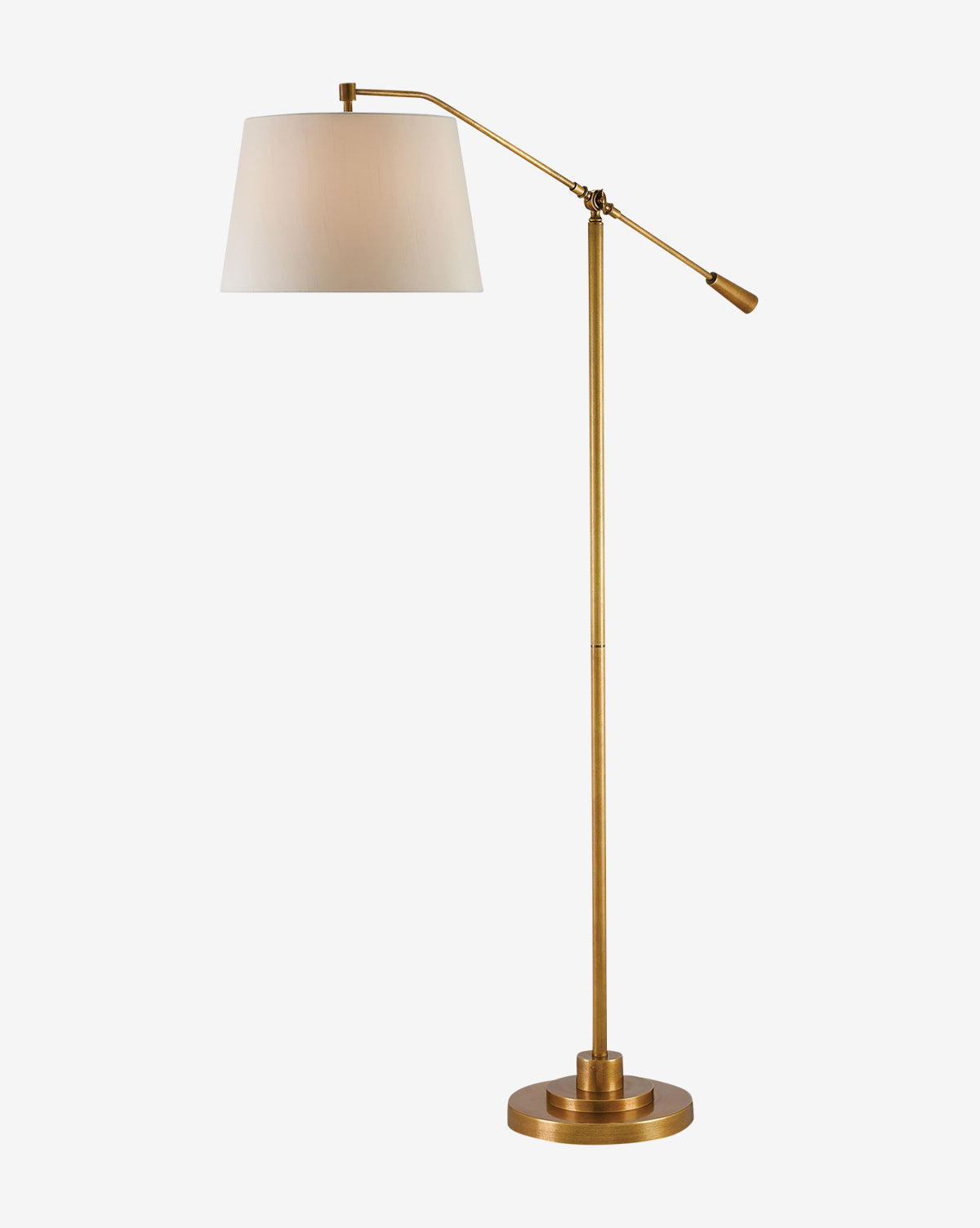 The Currey & Co. Maxstoke Floor Lamp is a tall, adjustable brass lamp with a round base and white drum shade—perfect as a stylish task light against a plain white background. McGee & Co.