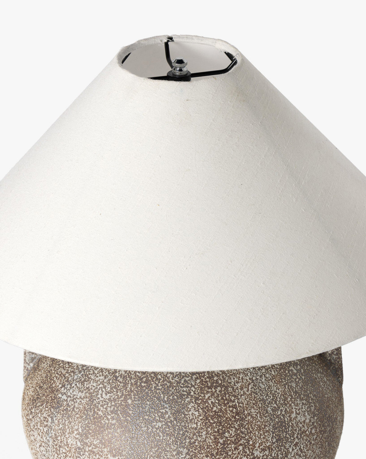 The Mays Table Lamp features a textured speckled brown base, inspired by vintage clay jars, paired with a wide off-white conical shade. Shown against a plain white background, by McGee & Co.