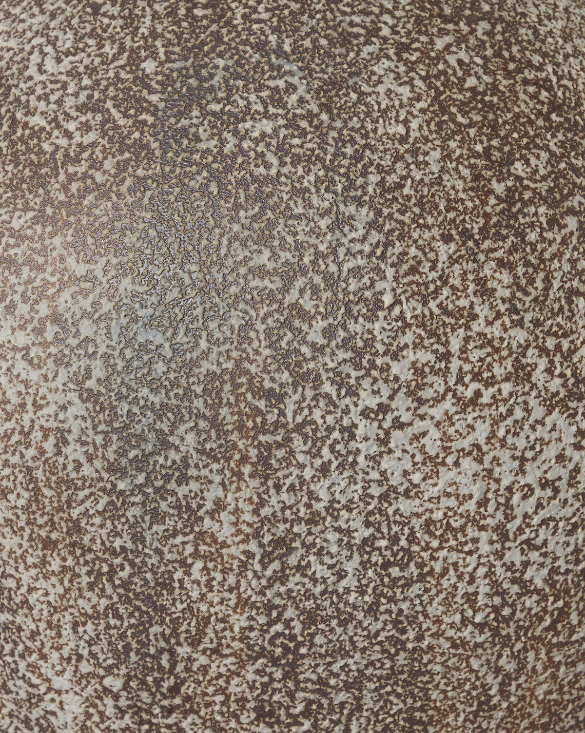 Close-up of the speckled brown and white textured surface of the Mays Table Lamp, reminiscent of a vintage clay jar or weathered sand-colored talavera glaze, by McGee & Co.