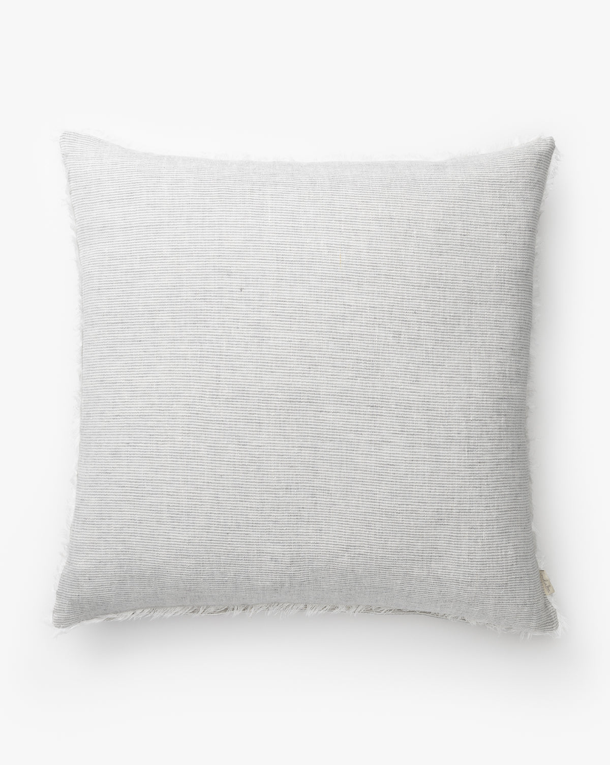The McCallen Pillow is a rectangular, light gray linen pillow with soft textured fabric and a subtle fringe edge, shown on a plain white background by McGee & Co.