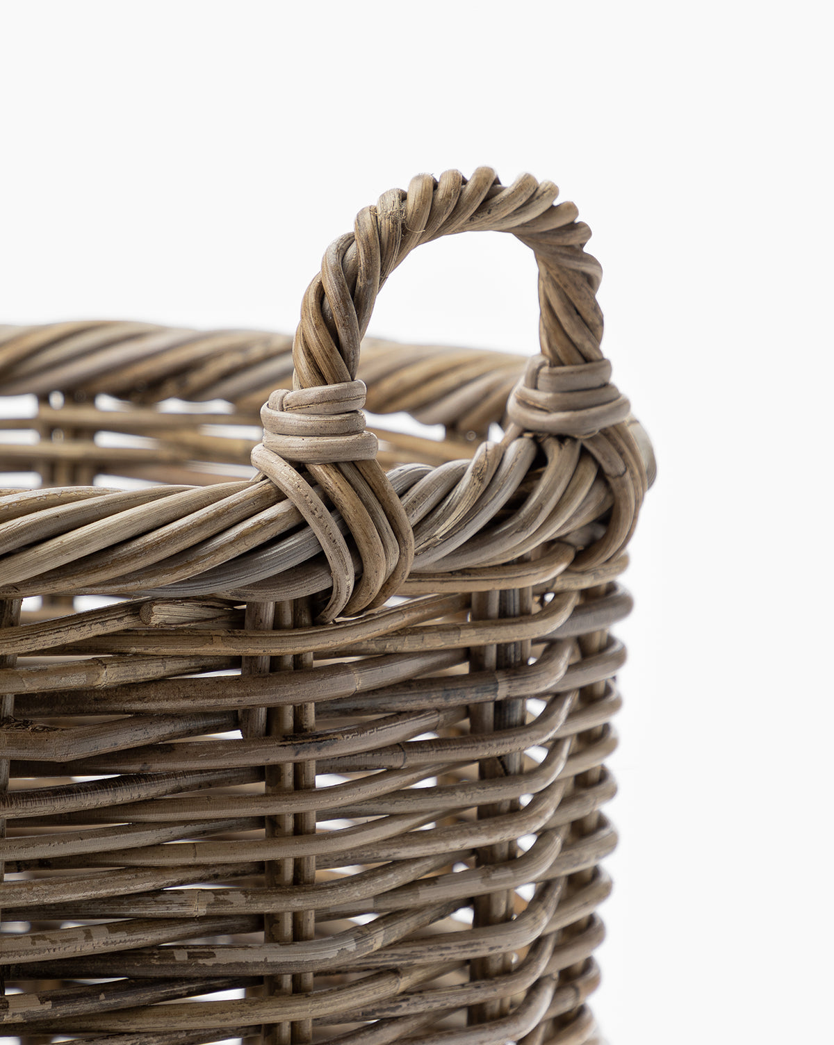 Close-up of the Mckell Basket with a sturdy handle, showcasing its detailed woven texture and craftsmanship from natural materials against a white background.