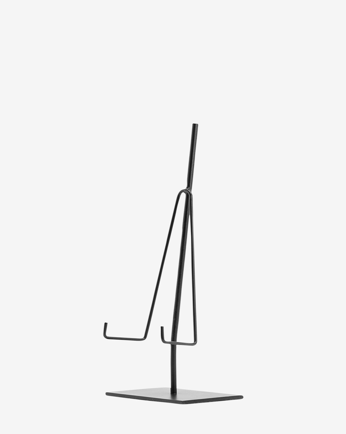 The Metal Easel is a minimalist black metal stand with a rectangular base and two angled hooks, ideal for displaying art or decorative items. Shown against a plain white background.