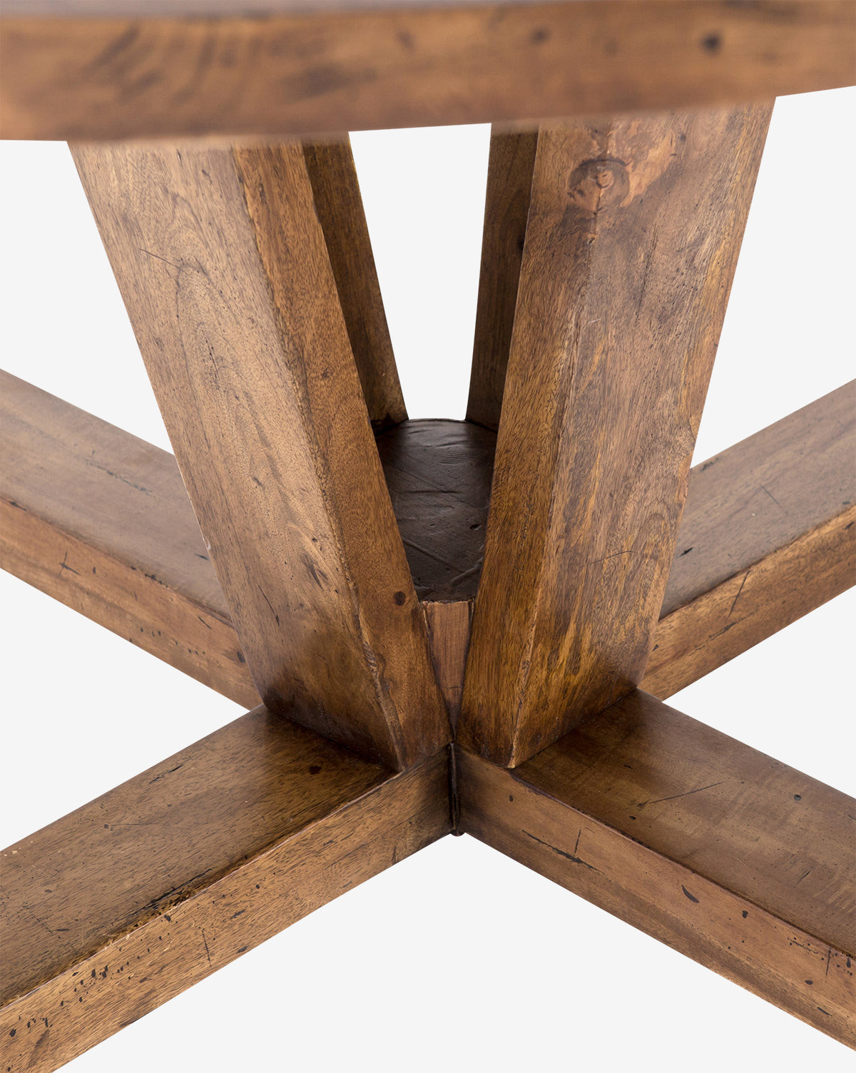 Close-up of the Mia Dining Table’s wooden base, showcasing intersecting angled legs and a central support crafted from reclaimed wood in a warm brown rustic finish.