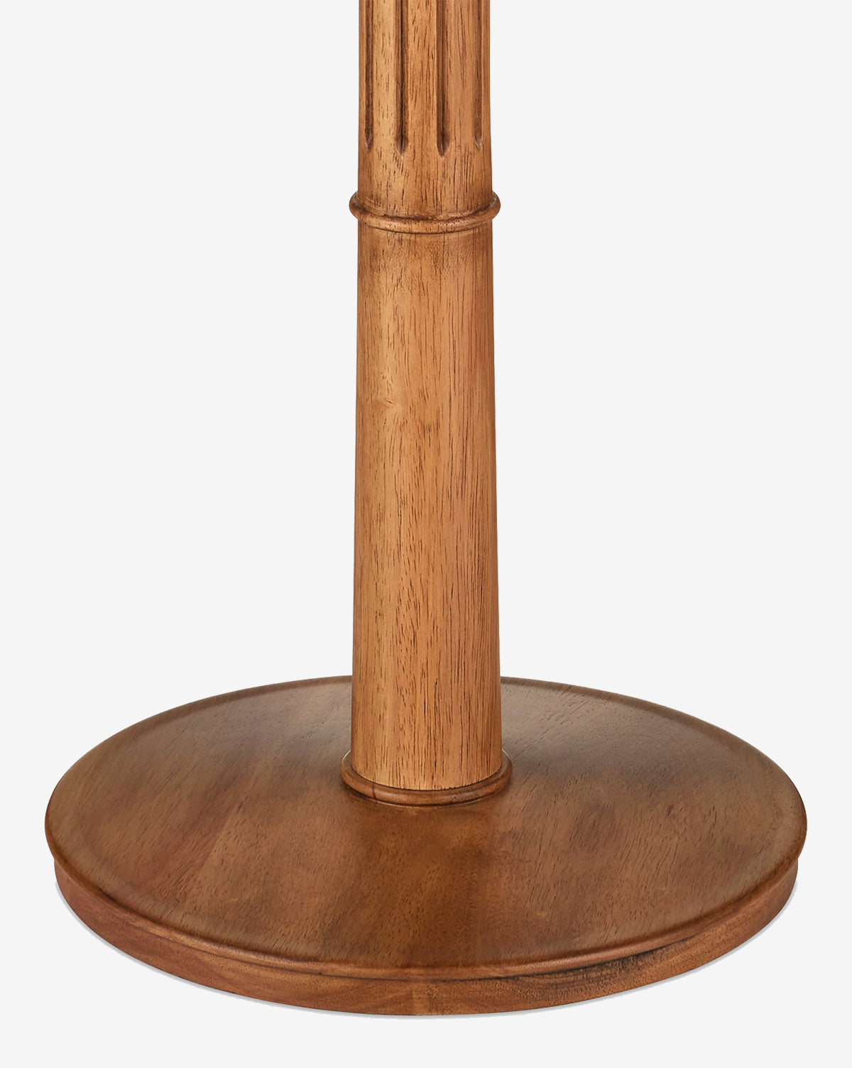 A close-up of the Mitford Floor Lamp’s natural wood base and vertical column with carved grooves near the top, shown against a white background, by McGee & Co.