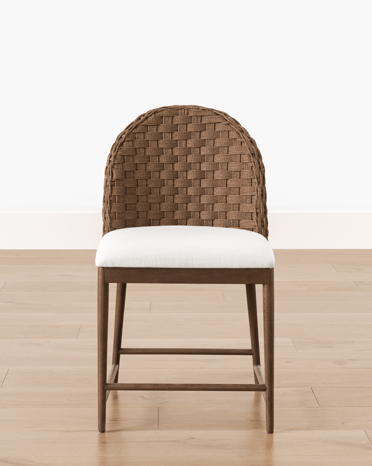 The Molly Dining Chair boasts a woven, rounded backrest and white cushioned seat, making it an ideal modern piece for contemporary dining spaces, by McGee & Co.