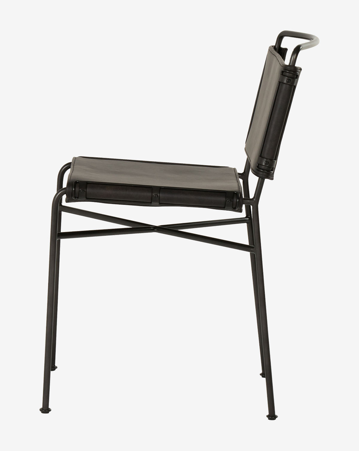 The Moore Dining Chair showcases a minimalist industrial design with a flat leather seat and backrest, seen from the side against a plain white background, by McGee & Co.