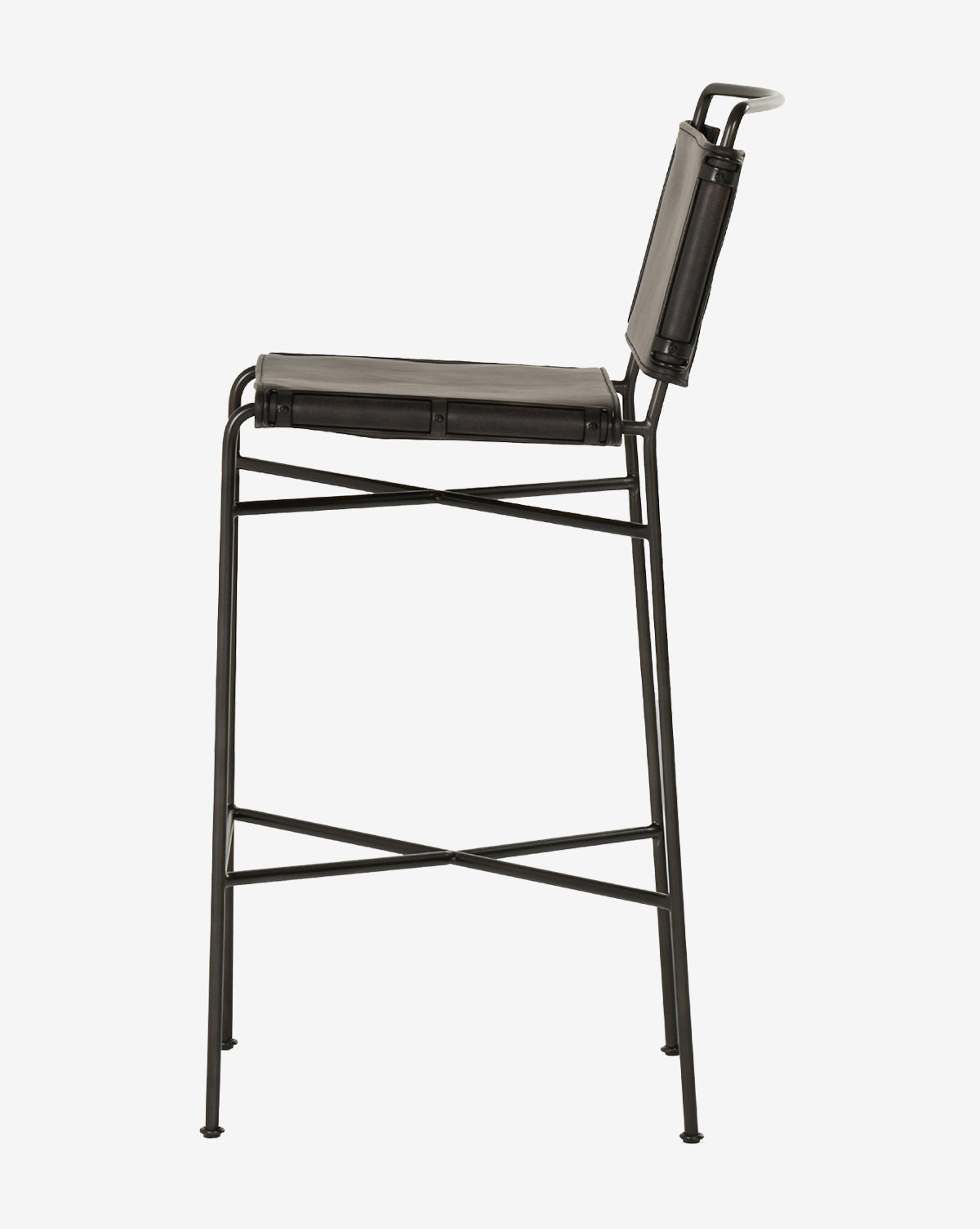 The Moore Stool features a black metal frame with a leather seat and backrest, slim legs, crossbar supports, and a minimalist industrial design. Shown in profile against a white background by McGee & Co.