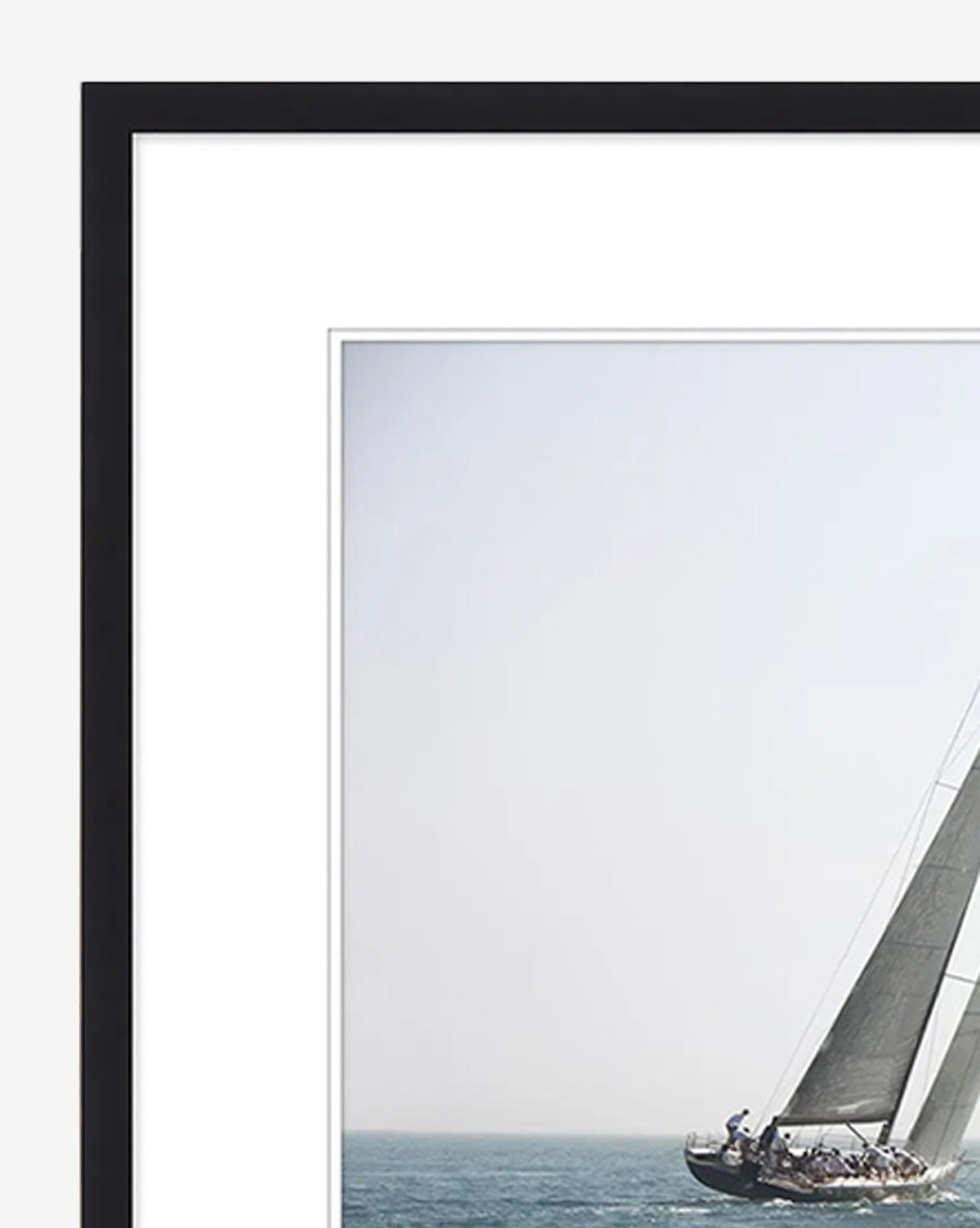 Motion is a framed giclee print featuring a sailboat heeling under full sail with crew aboard, set against a calm ocean and pale sky—ideal wall art to bring tranquil coastal vibes to your home, by McGee & Co.