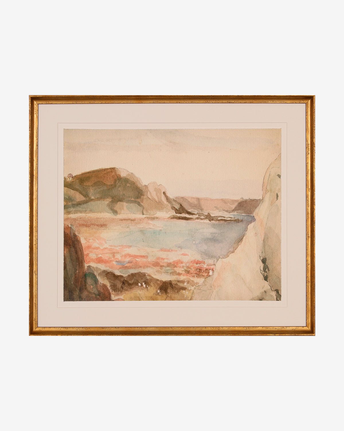 Mountain Reserve is a watercolor painting depicting cliffs and hills by calm water, in soft earth tones. This serene mountain decor comes framed with a simple gold frame and white mat for an elegant touch.