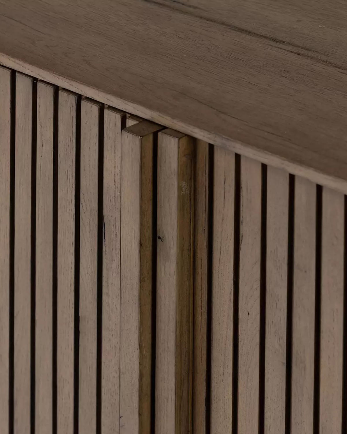 Close-up of the Murron Sideboard’s wooden construction and vertical slats. Fluted door fronts showcase the natural grain, creating modern geometric patterns with light and shadow—ideal for stylish entryway storage by McGee & Co.