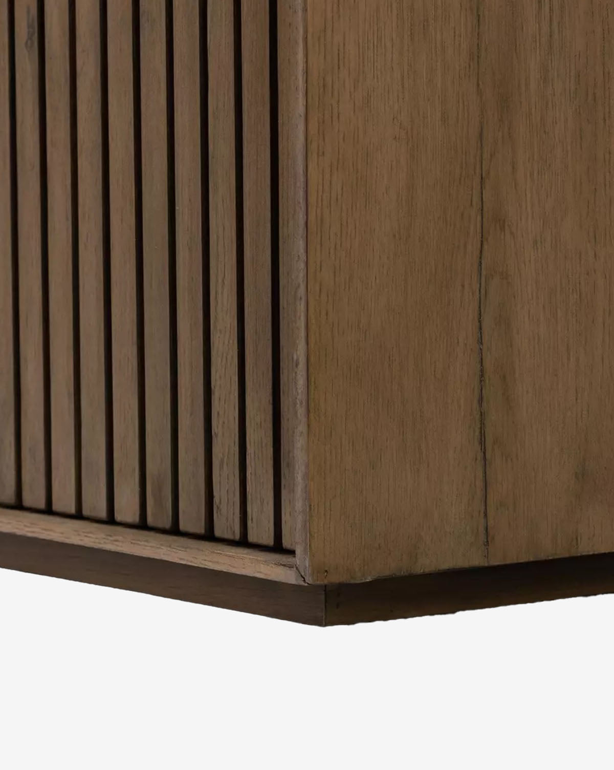 Close-up of the Murron Sideboards corner, showcasing vertical slats reminiscent of fluted doors on one side and a smooth wood panel on the other, highlighting its natural wood grain and texture, by McGee & Co.