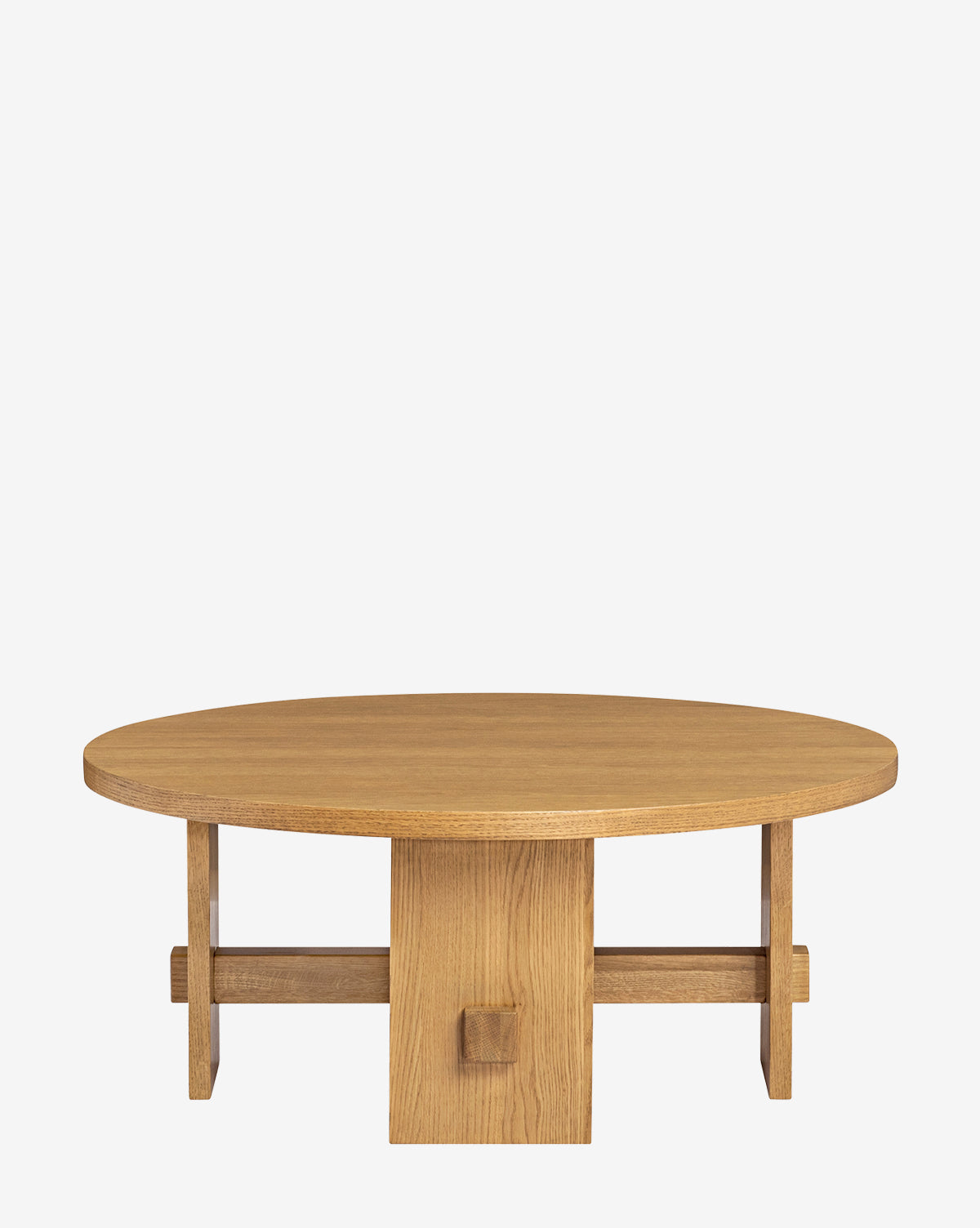 The Newbold Coffee Table is a round oak table with a smooth top and sturdy geometric base made of intersecting planks, finished in warm honey, shown on a plain white background, by McGee & Co.