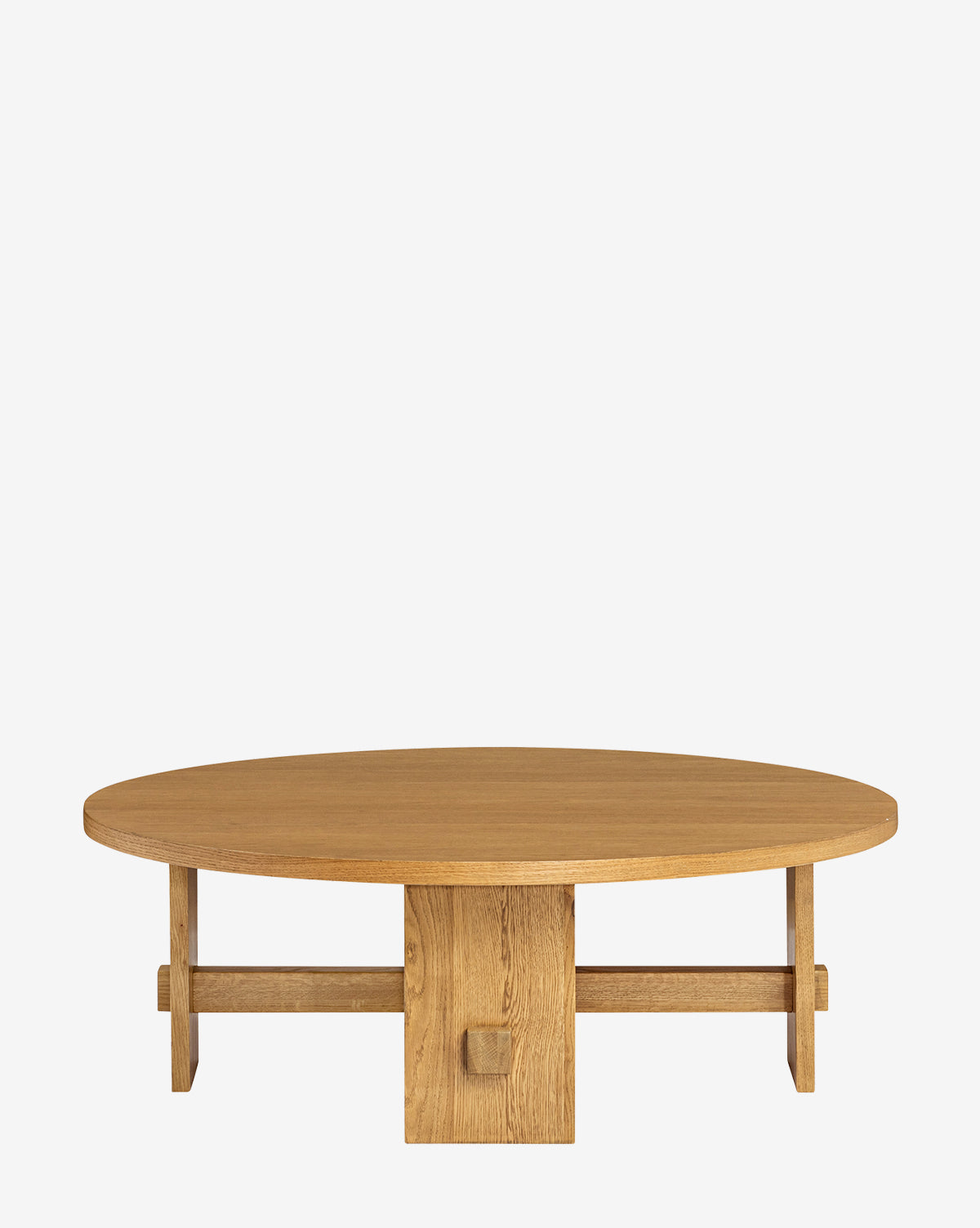 The Newbold Coffee Table is a round oak table with a honey finish, featuring a thick top and a unique geometric base of intersecting beams, shown against a plain white background, by McGee & Co.