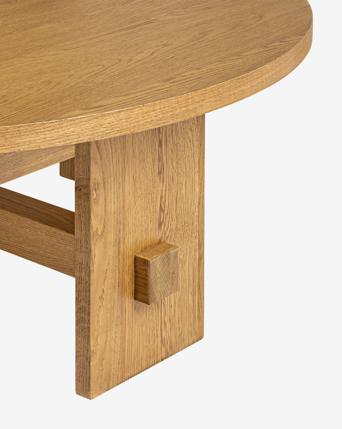 Close-up of the Newbold Coffee Table, highlighting its round top, sturdy block leg, natural oak wood grain, and honey finish set against a simple white background, by McGee & Co.