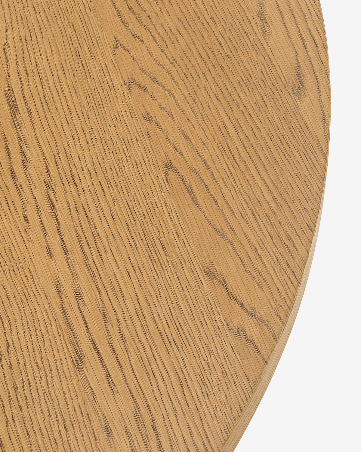 Close-up of the Newbold Coffee Table, a round oak piece in light brown with a honey finish, highlighting its natural wood grain against a plain white background, by McGee & Co.