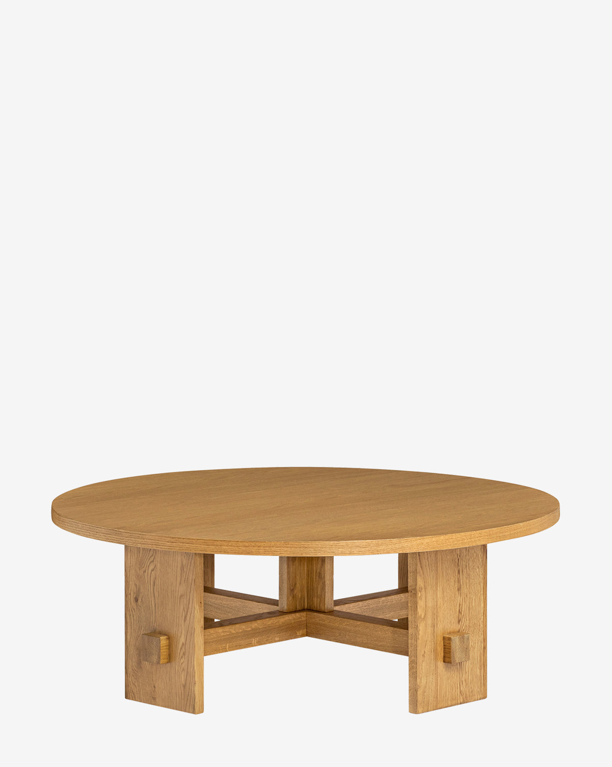 The Newbold Coffee Table is a round oak table with sturdy intersecting legs, a smooth top, and a natural honey finish, boasting a minimalist design against a plain white background, by McGee & Co.