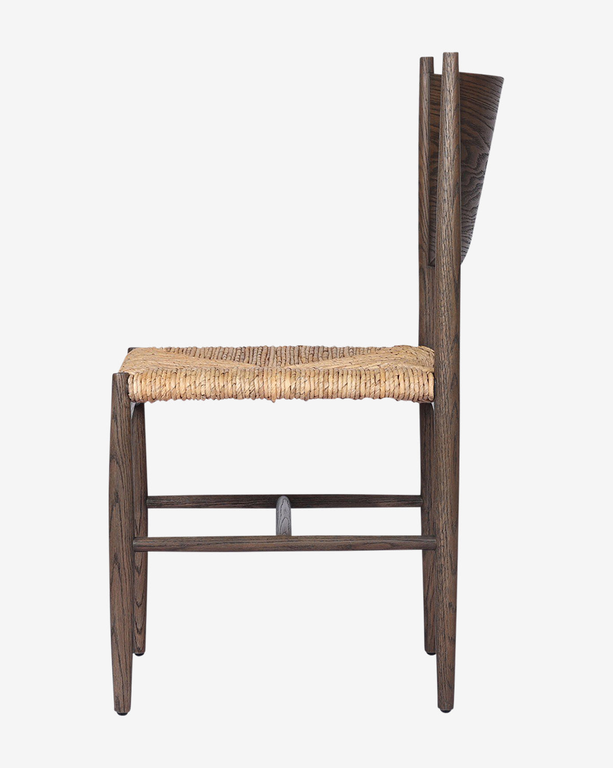 Side view of the Nixie Dining Chair, crafted from solid oak with a woven straw seat and a straight, tall backrest. Features a minimalist rustic design and is shown against a plain white background, by McGee & Co.