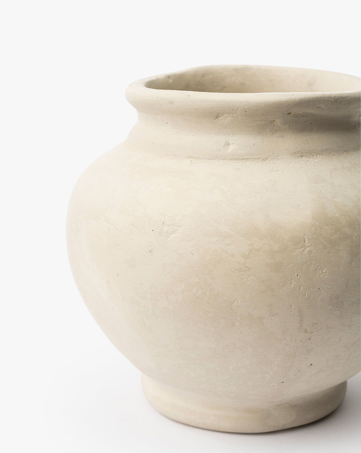 A close-up of the Nola Paper Mache Vase—a round, cream-colored piece with a wide opening and subtle textured finish—set against a plain white background, by McGee & Co.