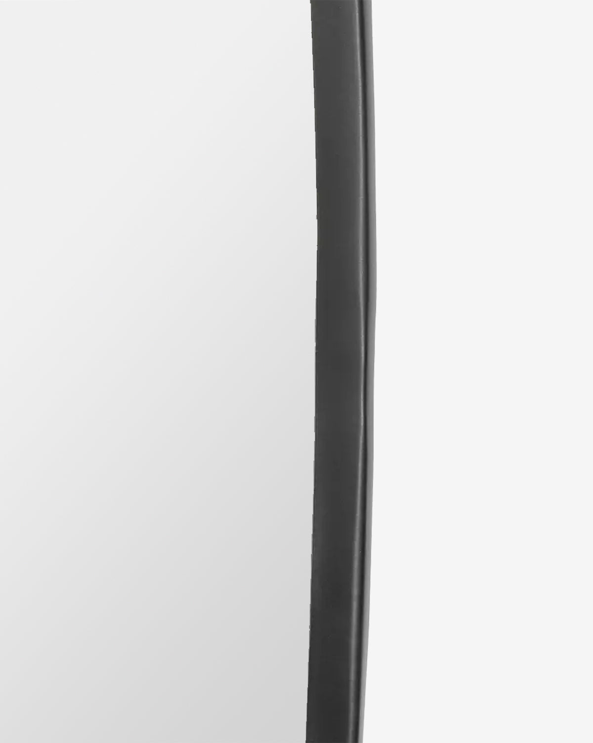 Close-up of the Nolie Wall Mirrors edge, showing its matte black, slightly wavy iron frame against a light gray background, by McGee & Co.