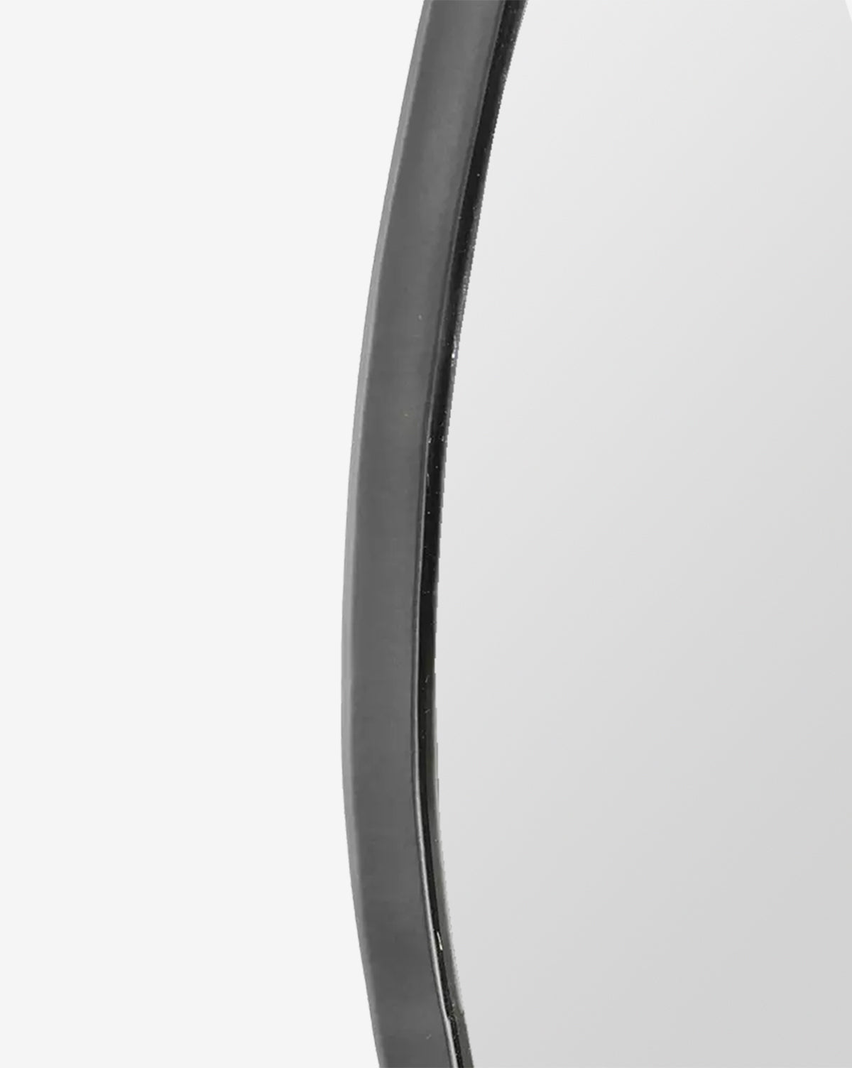 Close-up of the Nolie Wall Mirror’s edge, featuring a matte black iron frame with a smooth, curved contour set against a plain white background, by McGee & Co.