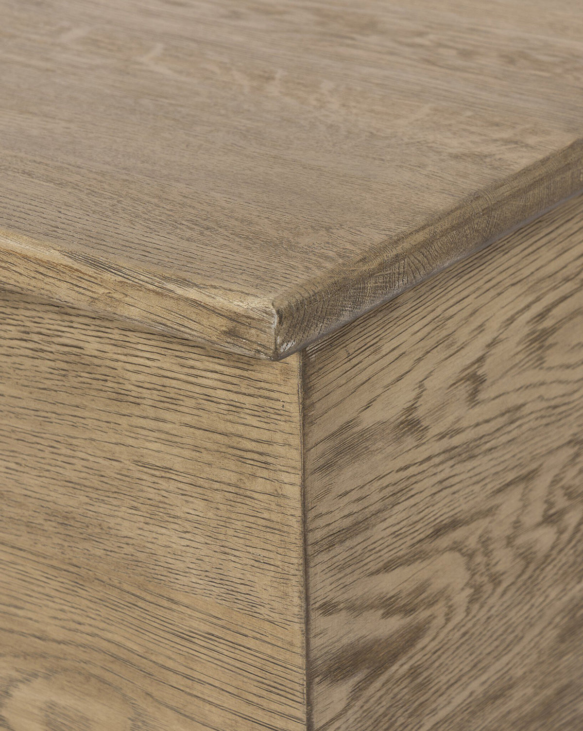 Close-up of the Norman Bench by Four Hands, highlighting the solid oak corner with a natural light brown finish that showcases the woods unique texture and grain—McGee & Co.