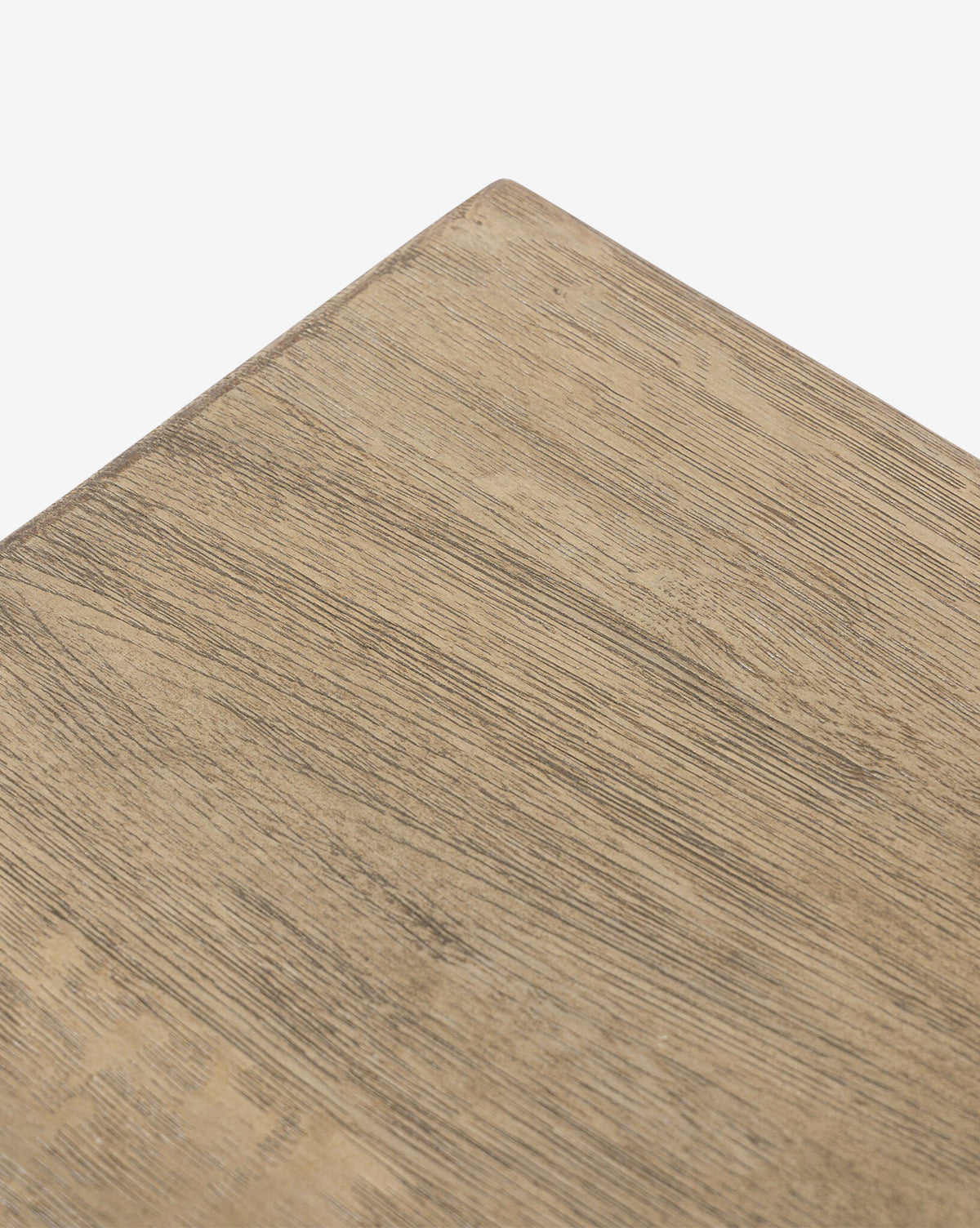 Close-up of the corner of the Four Hands Norman Bench, featuring solid oak with a light brown finish and visible wood grain, set against a plain white background. McGee & Co.