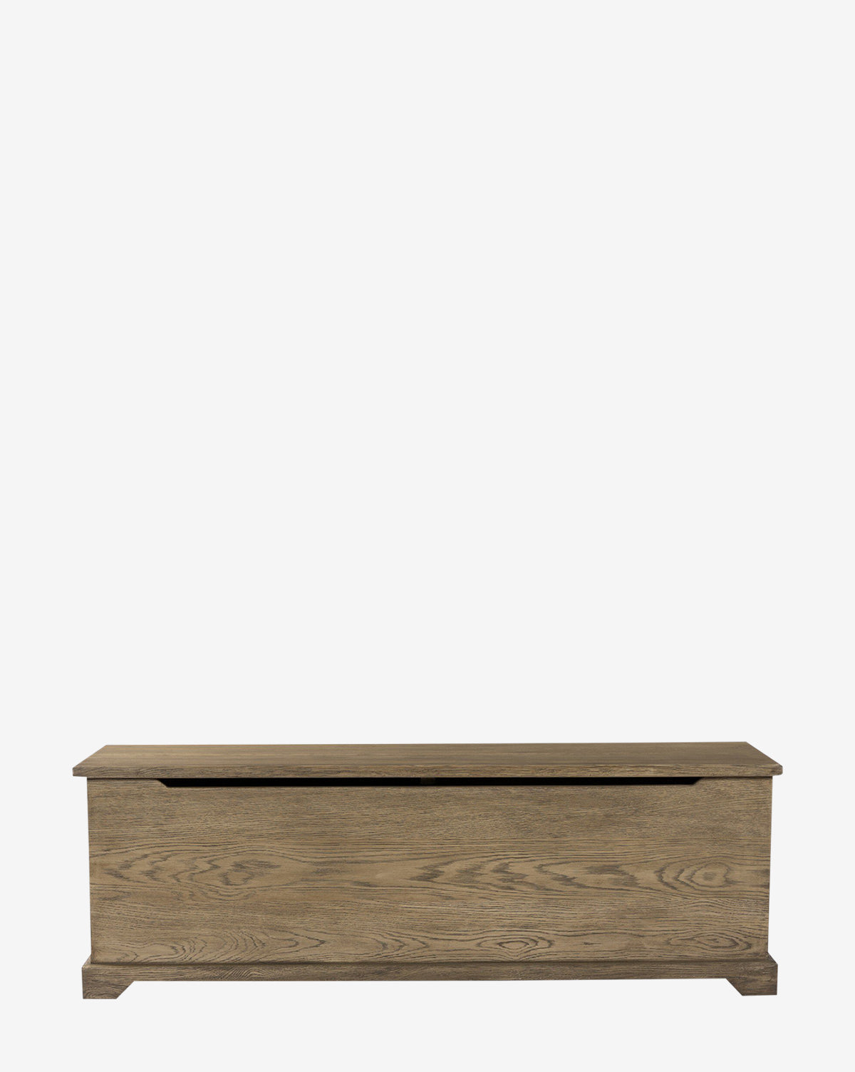 The Norman Bench by Four Hands is a solid oak rectangular bench with a hinged lid, natural wood grain finish, and built-in storage. Its simple design suits any entryway, shown here against a plain white background. McGee & Co.