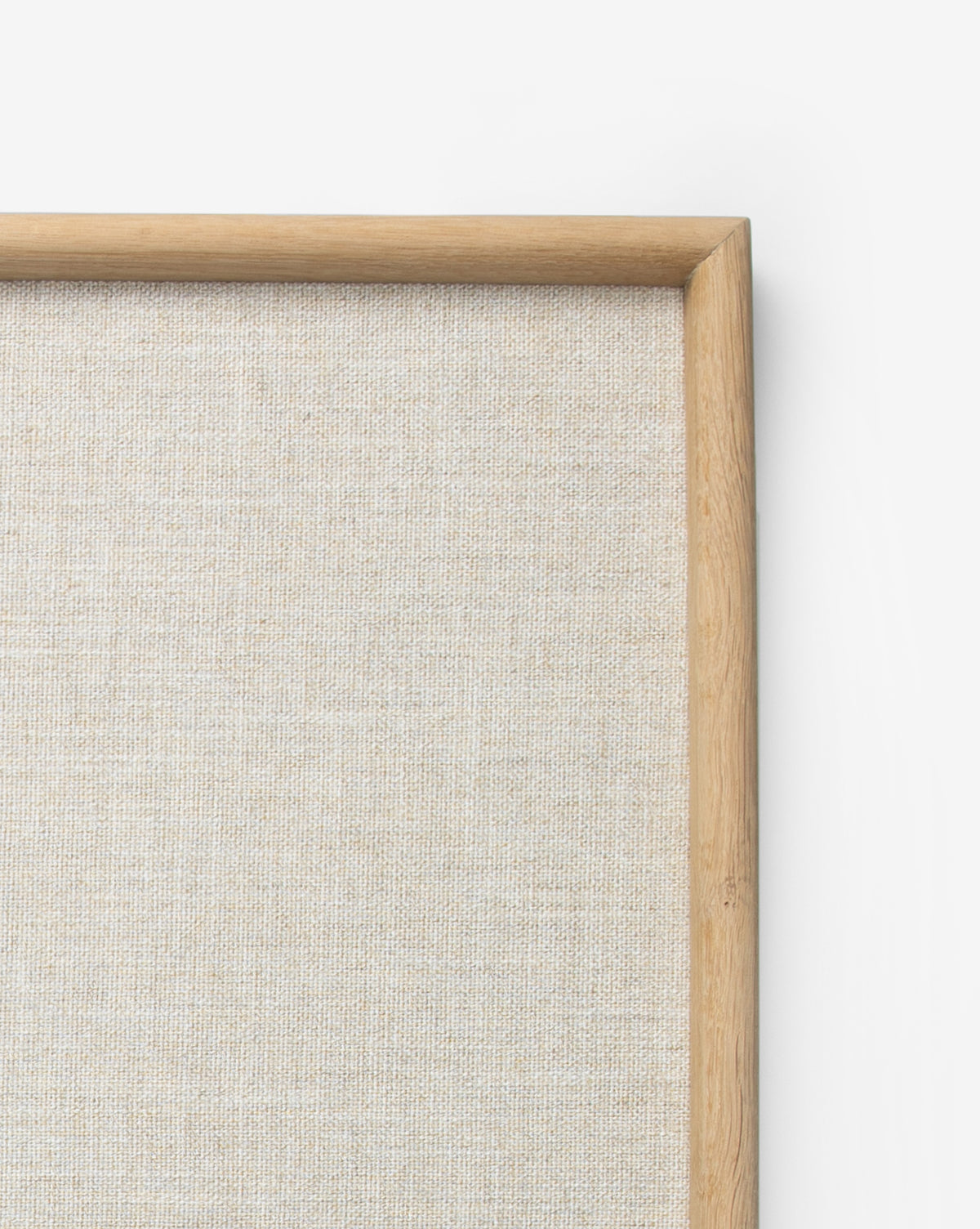 Close-up of the Oak & Linen Memo Board’s top right corner, featuring beige textured linen and a light wood frame against a white background—ideal for office organization.