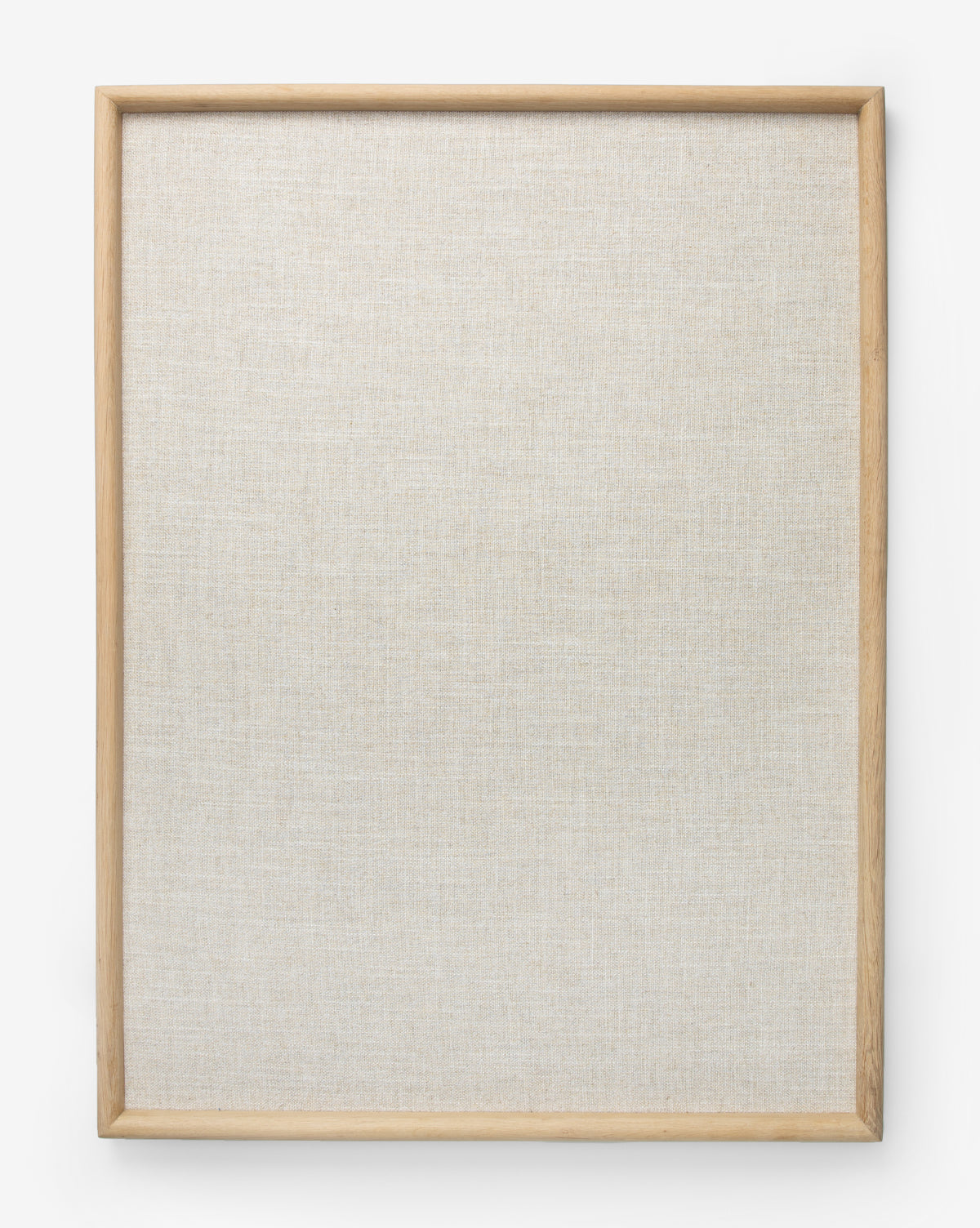 The Oak & Linen Memo Board is a square, blank linen board with a light oak frame. Set against a white background, its textured, unpainted canvas is ideal for keeping your office organized.