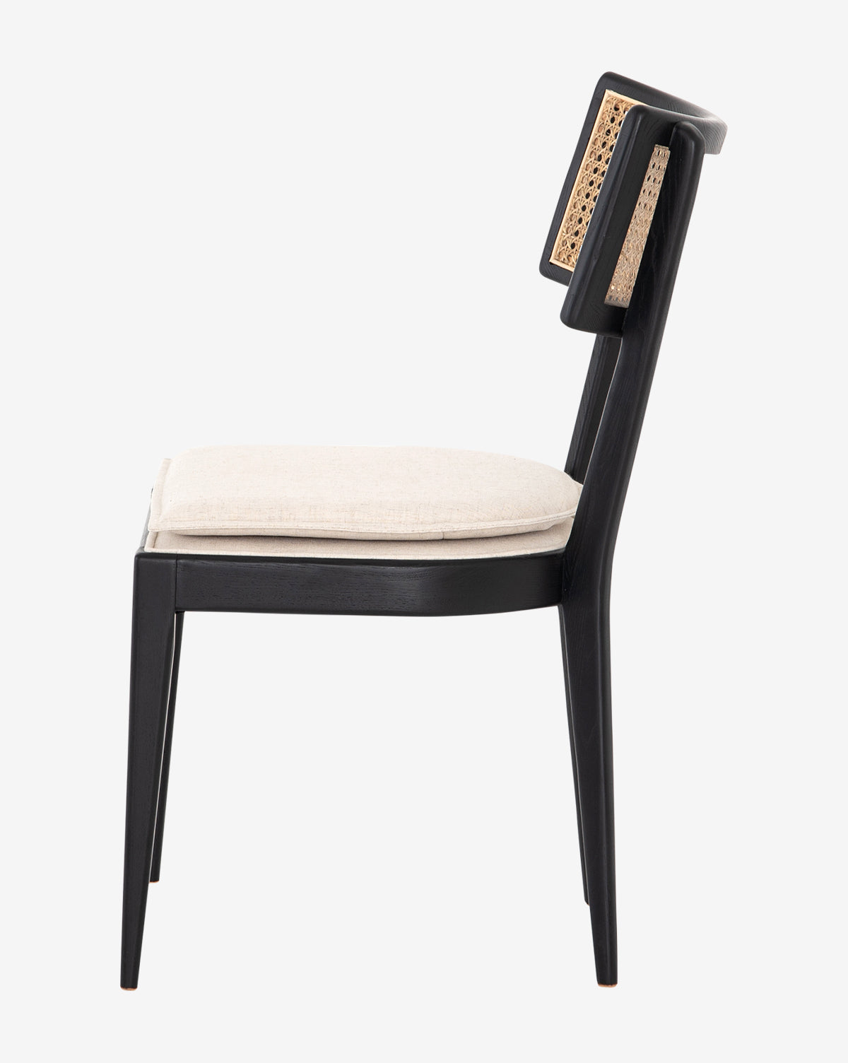 Side view of the Odelle Dining Chair, featuring a modern black wooden frame, woven cane-inlaid backrest, and light beige cushioned seat, displayed against a white background, by McGee & Co.