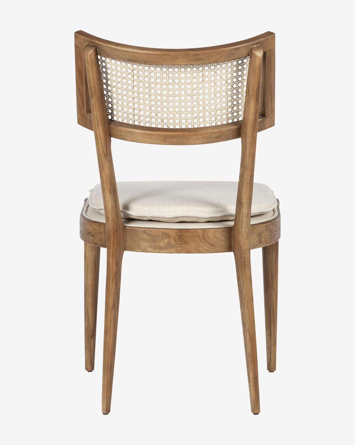 The Odelle Dining Chair features a curved backrest with woven cane, a light-colored cushioned seat, and angled legs, shown from the back by McGee & Co.