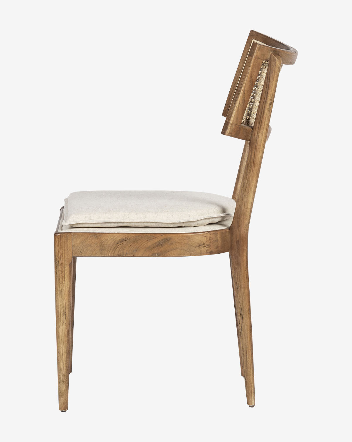 Side view of the Odelle Dining Chair, a modern chair with a light cushioned seat and slightly reclined backrest accented with cane inlaid detailing, showcasing its minimalist, contemporary design, by McGee & Co.