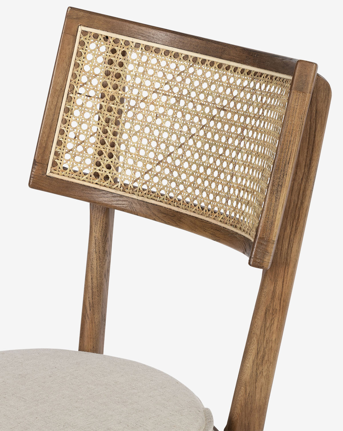 A close-up of the Odelle Dining Chair, showcasing its modern design with a woven cane backrest and light beige upholstered seat cushion, set against a plain white background, by McGee & Co.