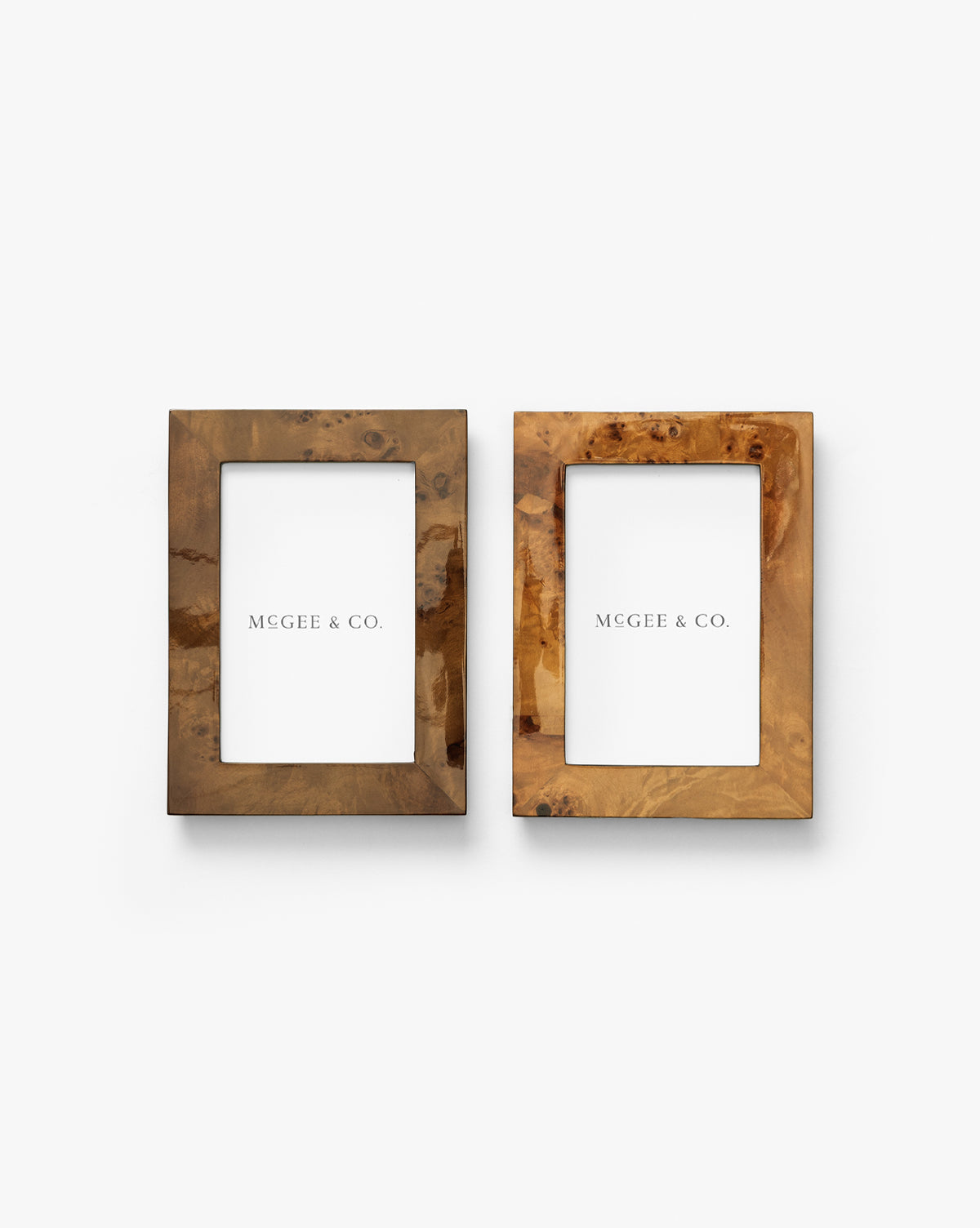 The Oliver Burl 4x6 Frames (Set of 2) feature a natural brown wood grain finish and come with MCGEE & CO. placeholders, making elegant additions to your home decor, by McGee & Co. Shown side by side on a white background.
