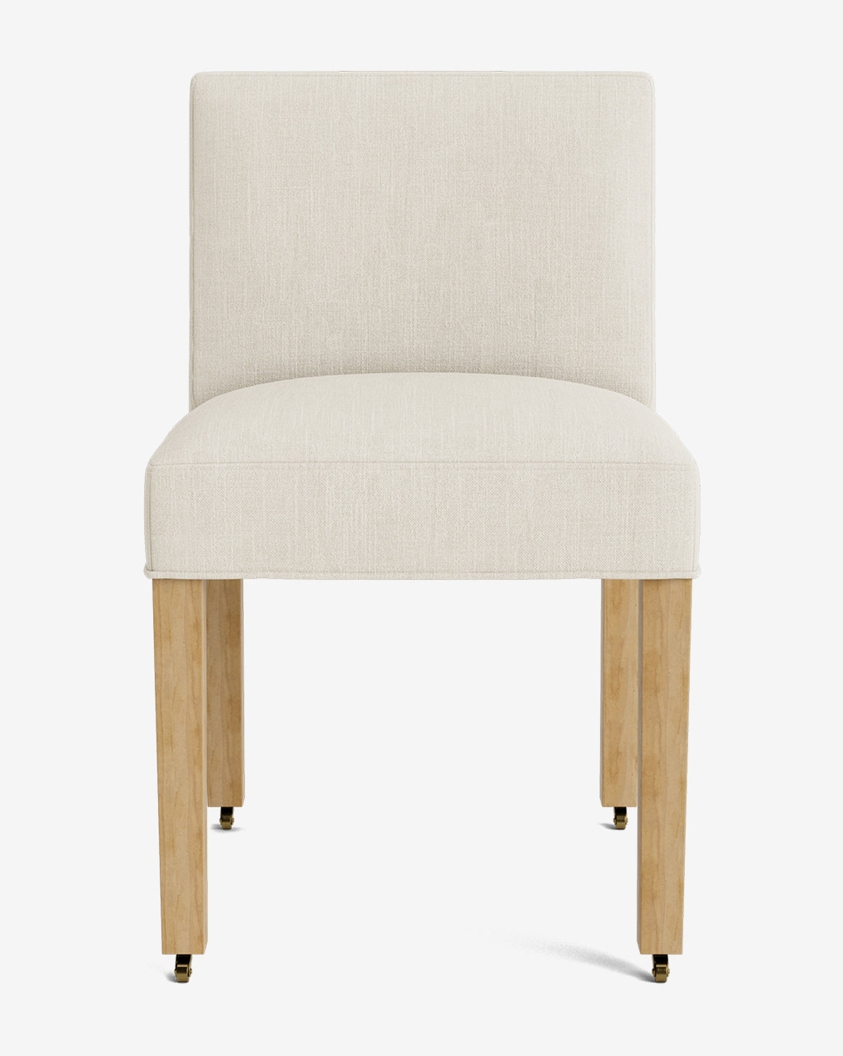 Front view of the Olivier Upholstered Dining Chair, featuring a modern armless design, cream high-quality fabric seat and backrest, and four light wood legs with brass casters on the front two legs, by McGee & Co.