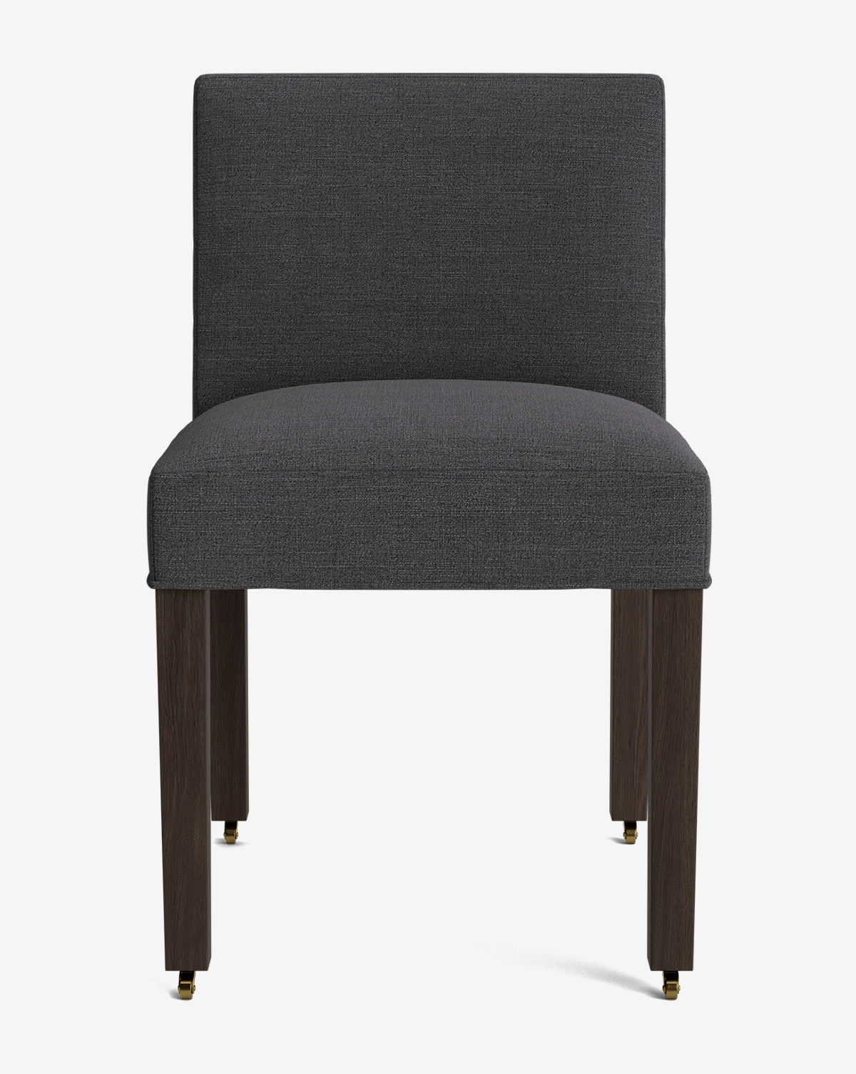The Olivier Upholstered Dining Chair features a straight, dark grey high-quality fabric seat and back, dark wooden legs, and small brass casters on the front legs, shown against a plain white background by McGee & Co.