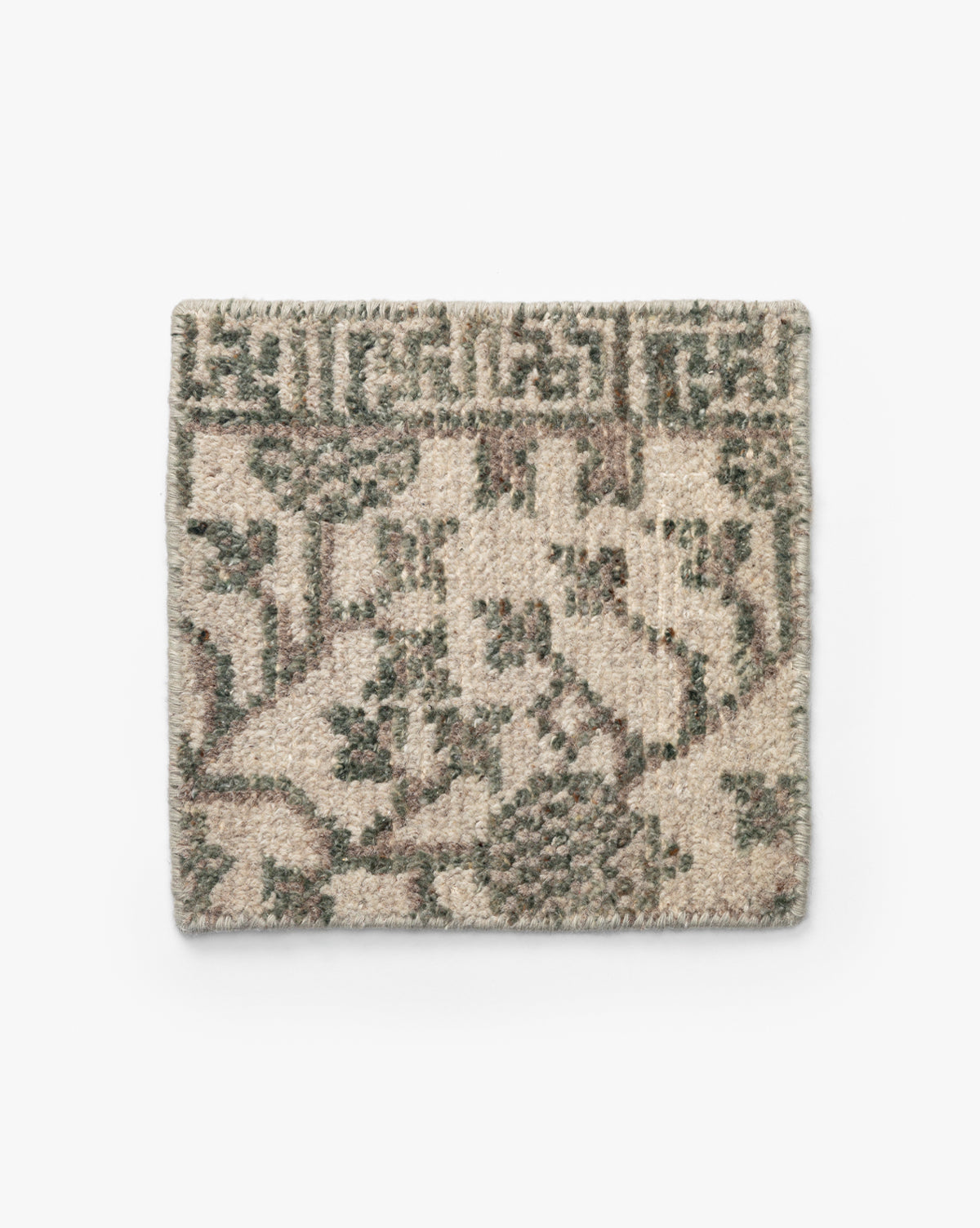 The Orsino Hand-Knotted Rug Swatch is a rectangular wool sample with a beige background and abstract green and brown geometric and floral patterns, shown on a plain white surface by McGee & Co.