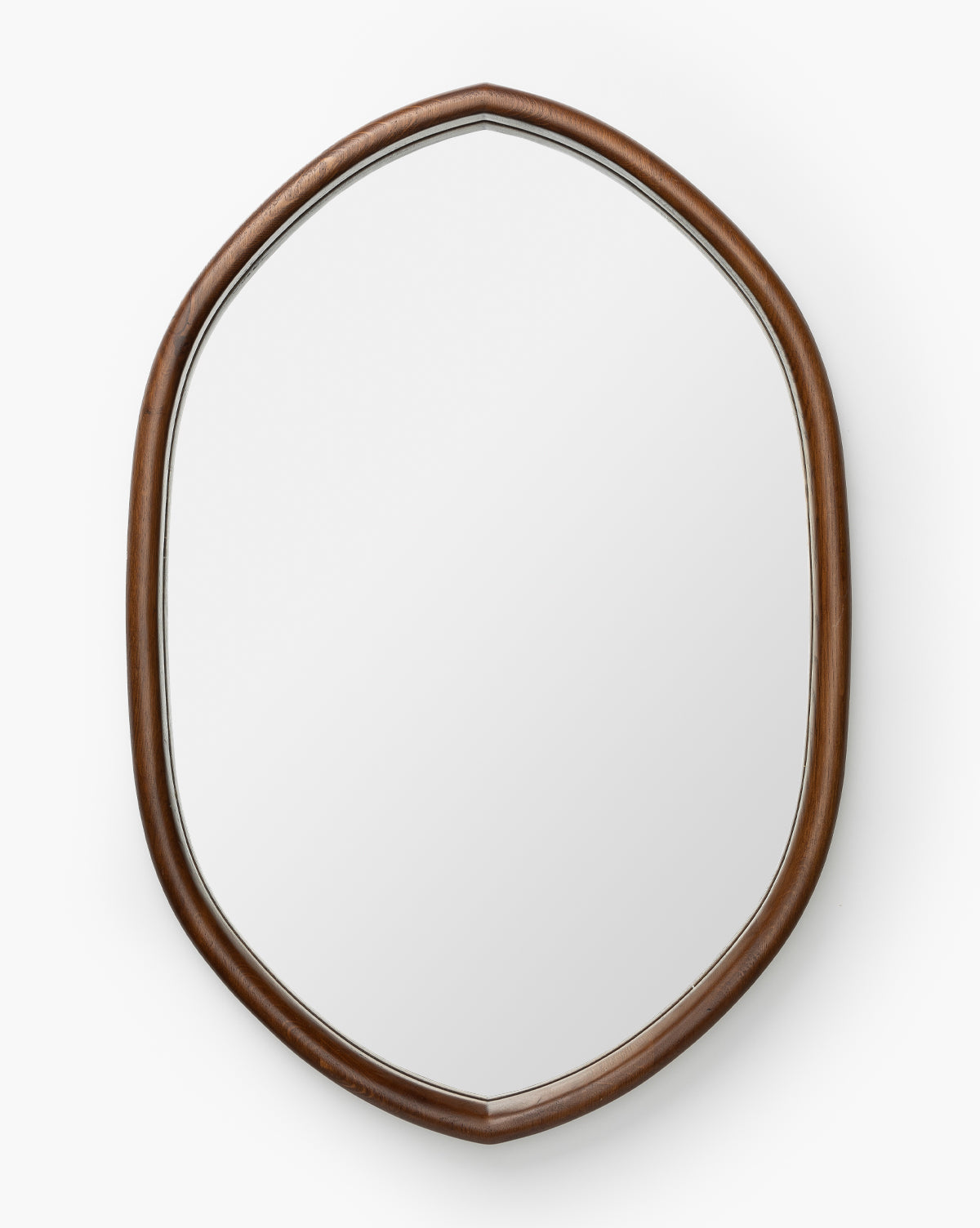 The Oslo Mirror has an oval shape with a smooth oak frame and gentle curves in a natural brown finish, set against a white background, by McGee & Co.