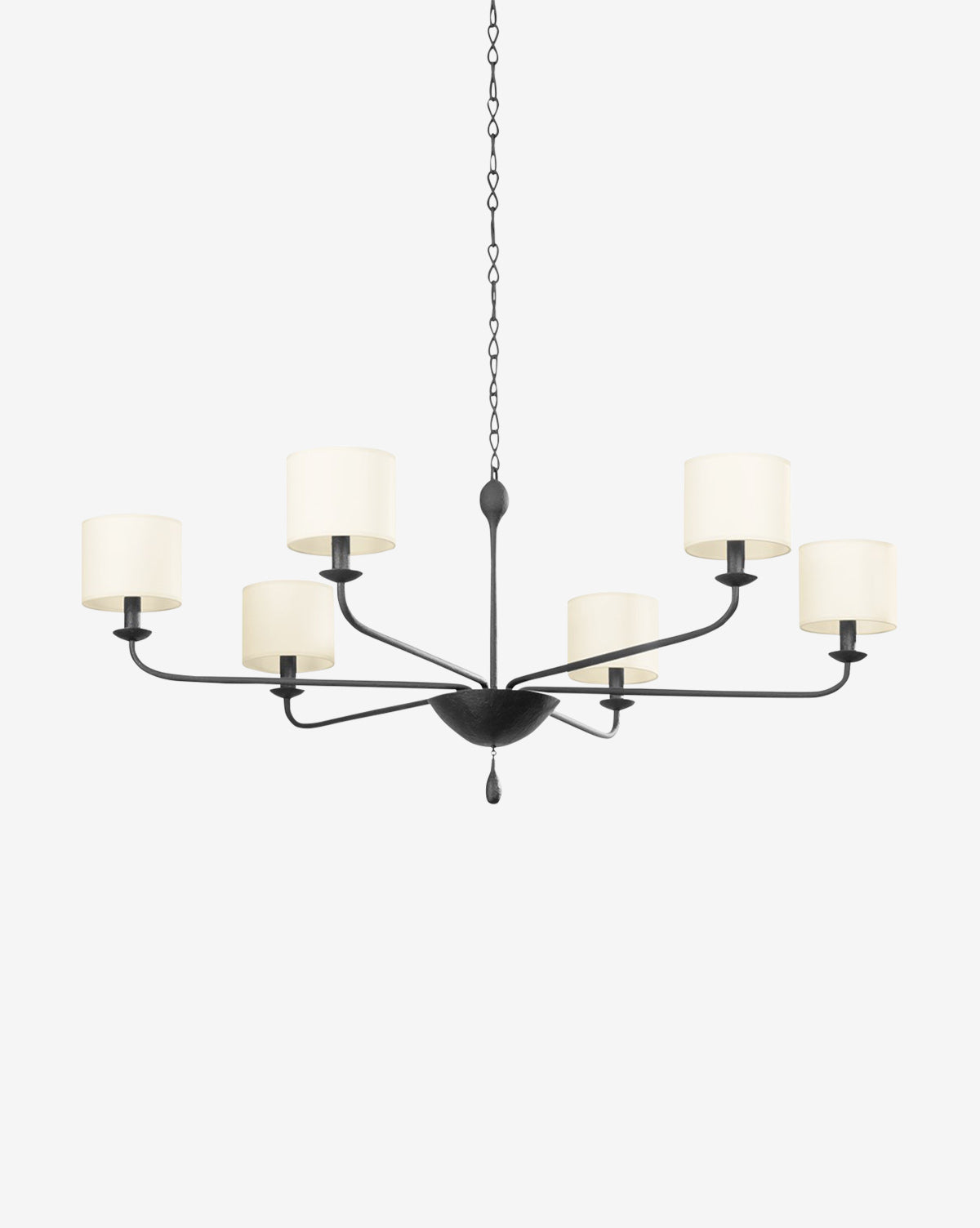 The Osmond Chandelier by Troy Lighting is a modern black iron fixture featuring six arms with cylindrical white lampshades for candelabra bulbs, all suspended by a chain. McGee & Co.