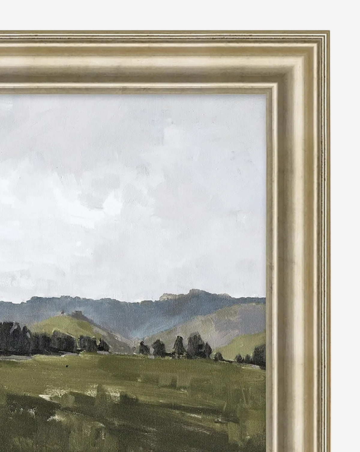 Overlook View II by Monique Lazard is a framed giclée print showcasing rolling green hills beneath a pale, cloudy sky, with fields and trees in the foreground. It comes in a wide, light-colored frame with a layered, textured design by McGee & Co.