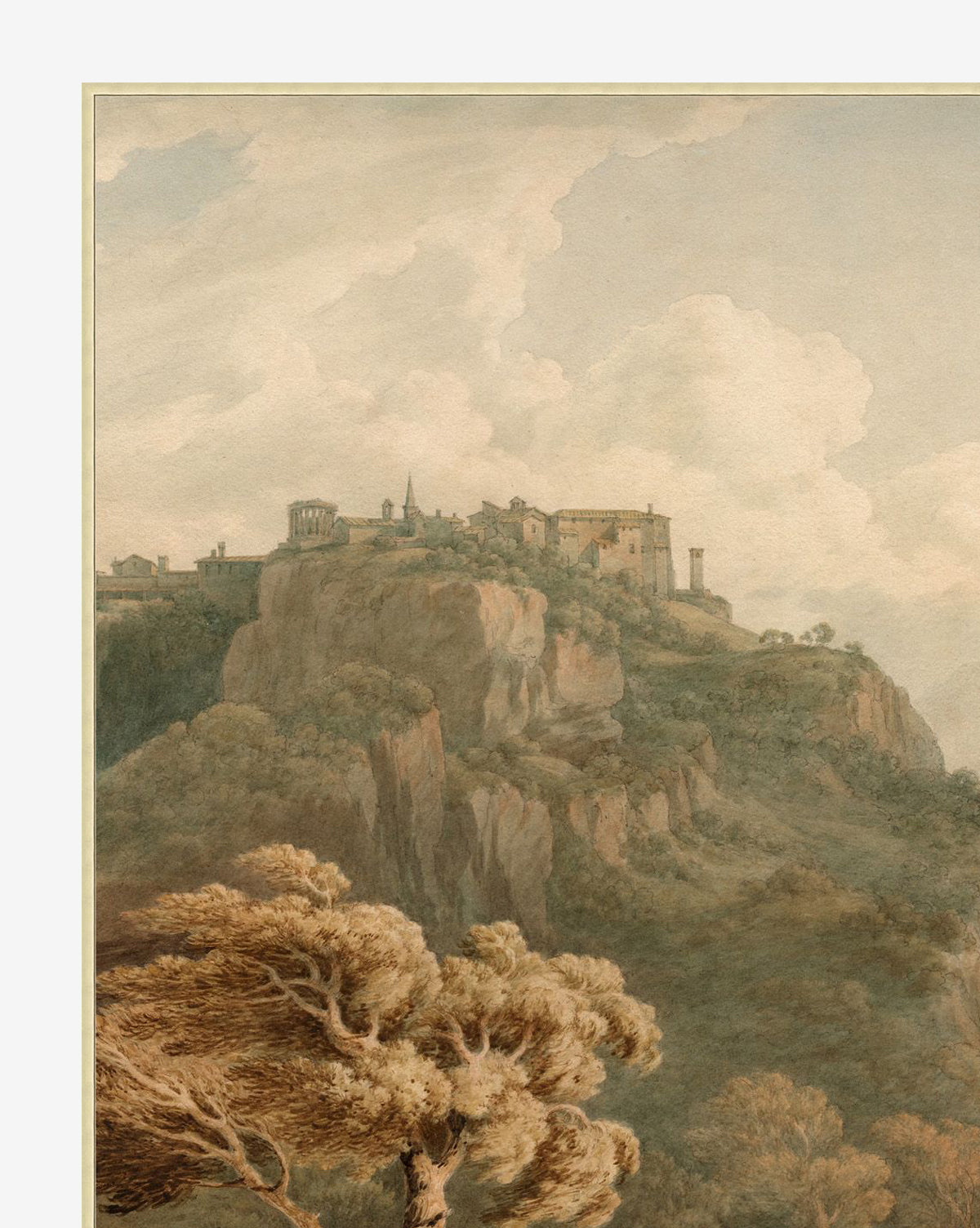Overlooking Tivoli is a scenic painting depicting a hilltop village with stone buildings and church atop cliffs, detailed brushwork, foreground trees, and a cloudy sky. Presented in a silver finished wood frame, by McGee & Co.