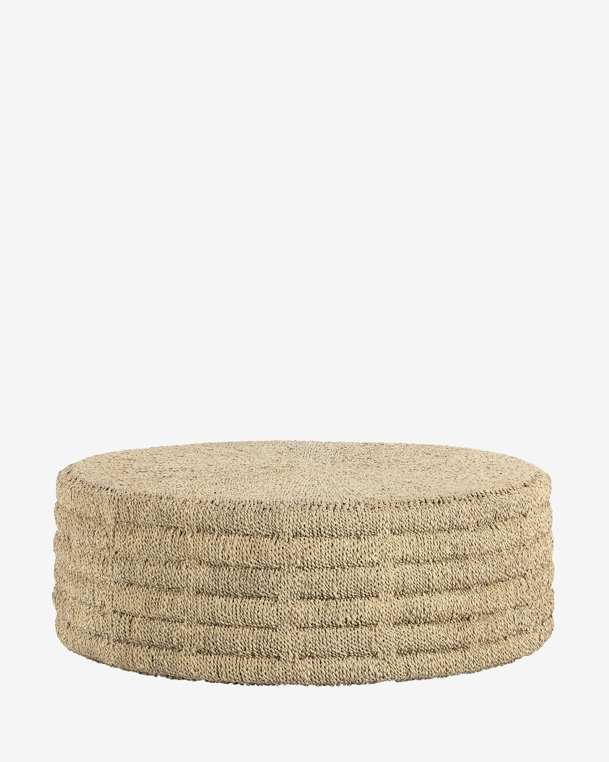 The Palmer Coffee Table is a round, hand-woven piece featuring a natural texture and ribbed sides, shown against a plain white background by McGee & Co.