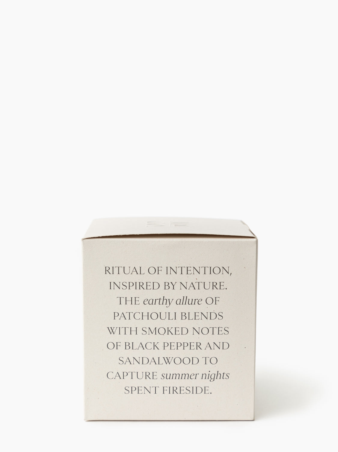 The Palo Santo & Oakmoss Candle comes in a beige box with elegant text: “A luxury soy candle blending earthy patchouli, black pepper, sandalwood, and Palo Santo for a fireside-inspired ritual of intention”, by McGee & Co.