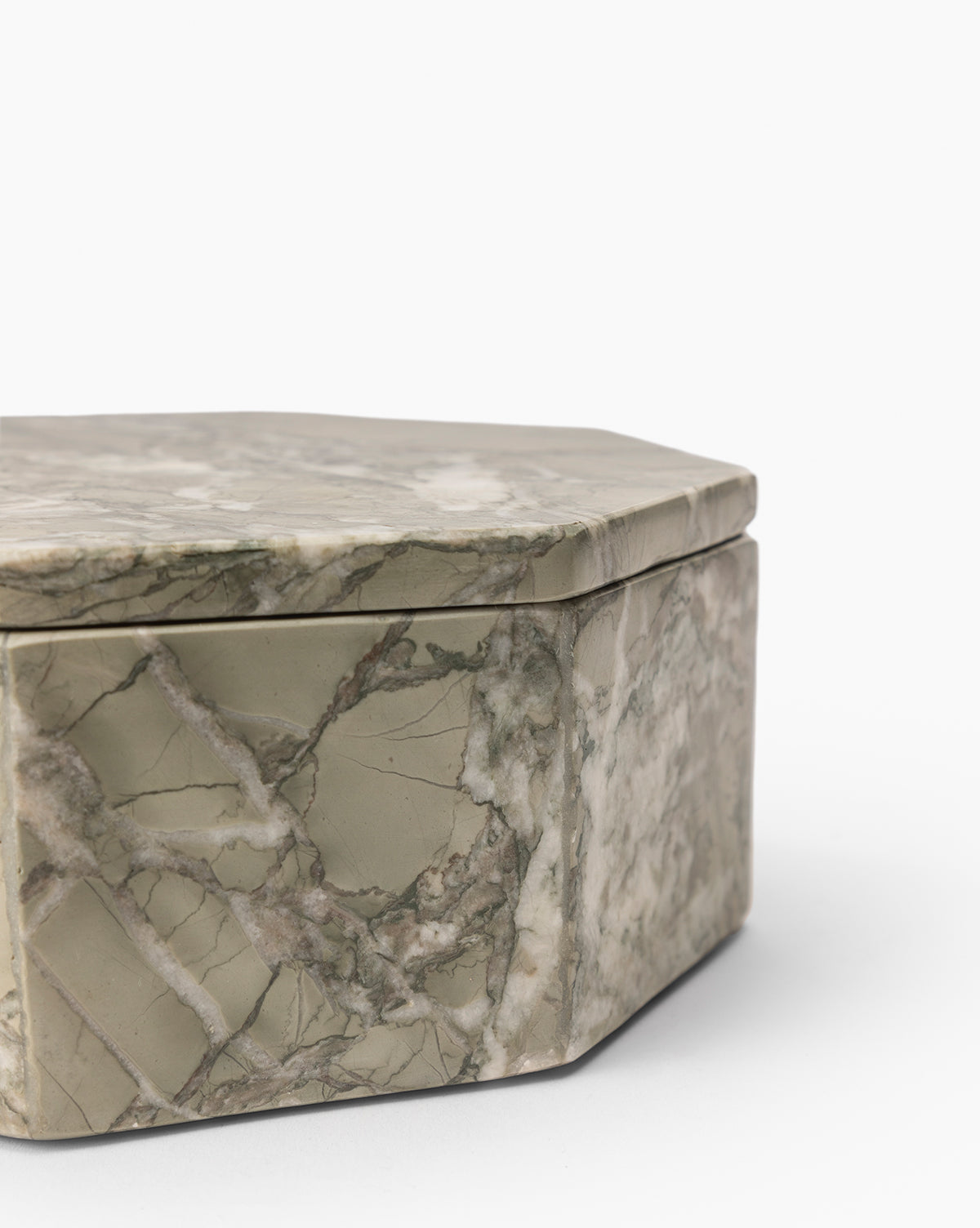 A close-up of the Paolo Marble Box shows its octagonal shape and lid, highlighted by natural gray-green marble veining, set on a plain white background. This decorative box brings sophisticated elegance to any space.