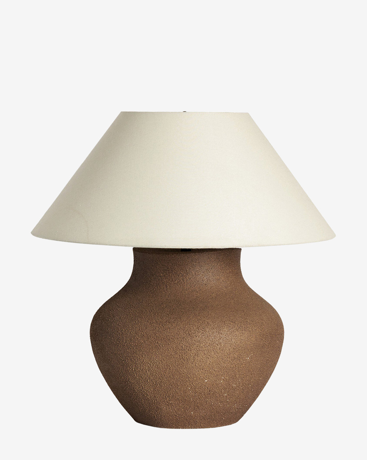 The Parma Table Lamp has a textured brown ceramic base and a wide ivory linen shade, shown against a plain white background, by McGee & Co.