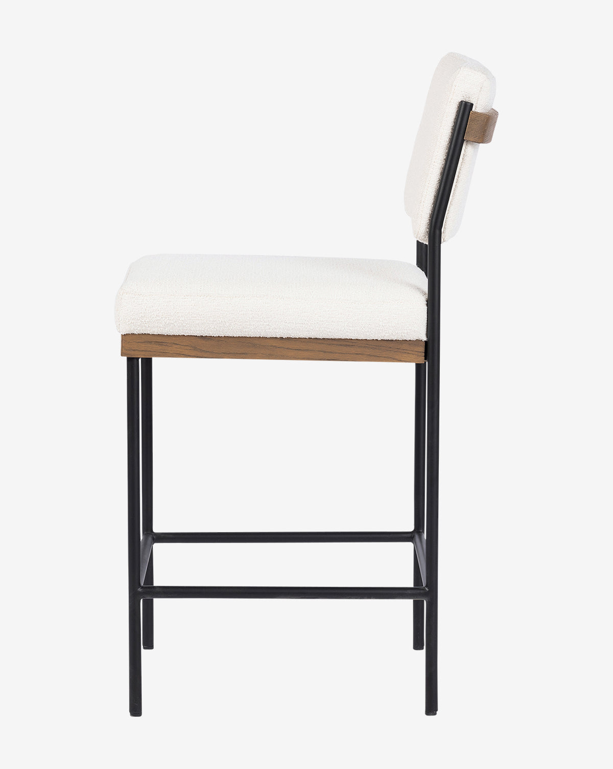 Side view of the Pascal Stool, featuring a white cushioned seat and backrest, slim black iron legs, and a wooden accent below the seat. Its minimalist, contemporary design makes it a versatile addition to modern spaces, by McGee & Co.