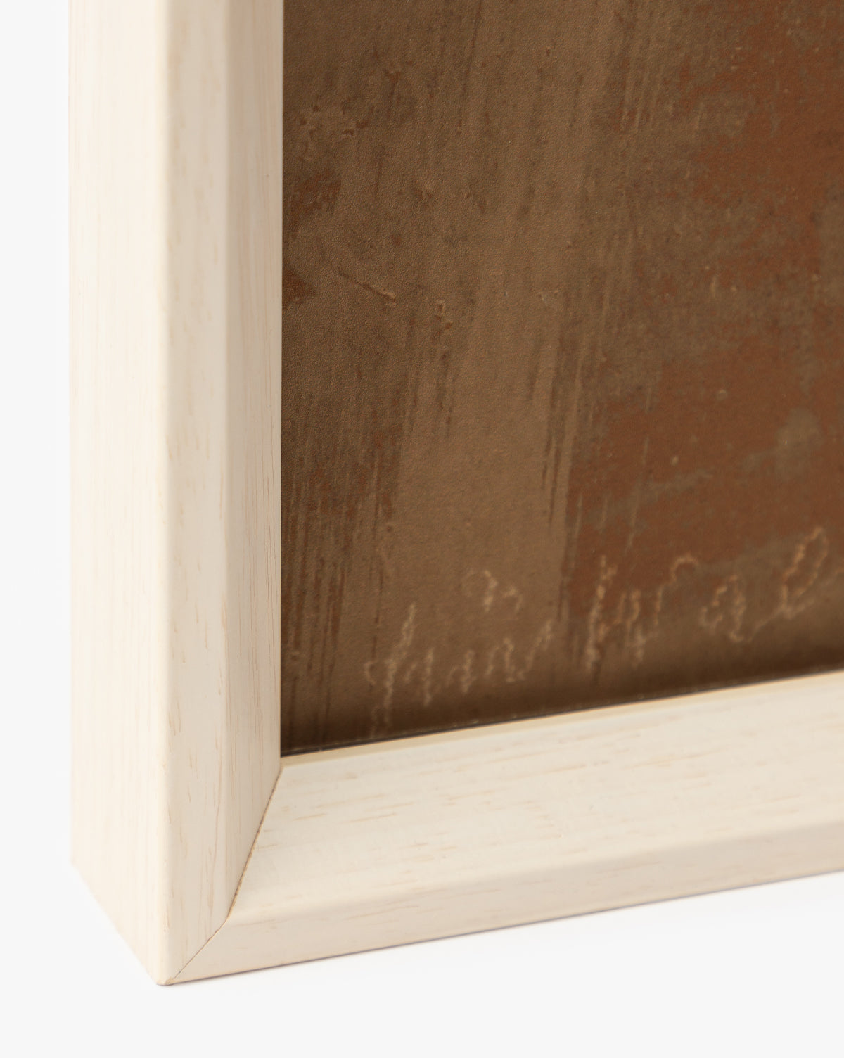 Close-up of the bottom left corner of a white wood frame with a light finish, featuring part of the Past Petals giclee prints textured brown artwork—an elegant, stylish home accent, by McGee & Co.