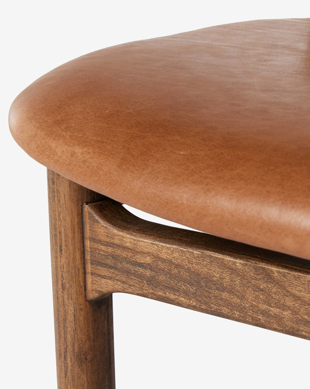 Certainly! Here’s your enriched sentence with the exact string McGee & Co. blended at the end: Close-up of the Four Hands Patrin Stool, featuring a performance light brown leather upholstered seat and an ash wood frame, highlighting the leather texture and natural wood grain—McGee & Co.