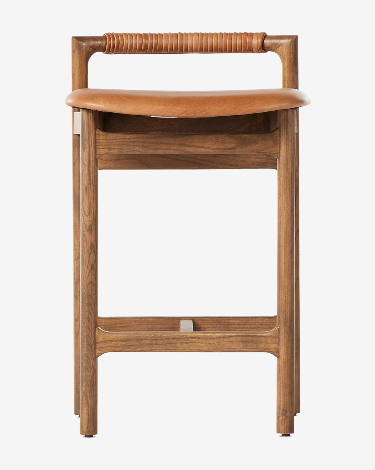 The Patrin Stool by Four Hands boasts an ash wood frame, a curved performance-upholstered seat, and a cylindrical leather-wrapped backrest. Straight legs with crossbars enhance its minimalist, modern style by McGee & Co.